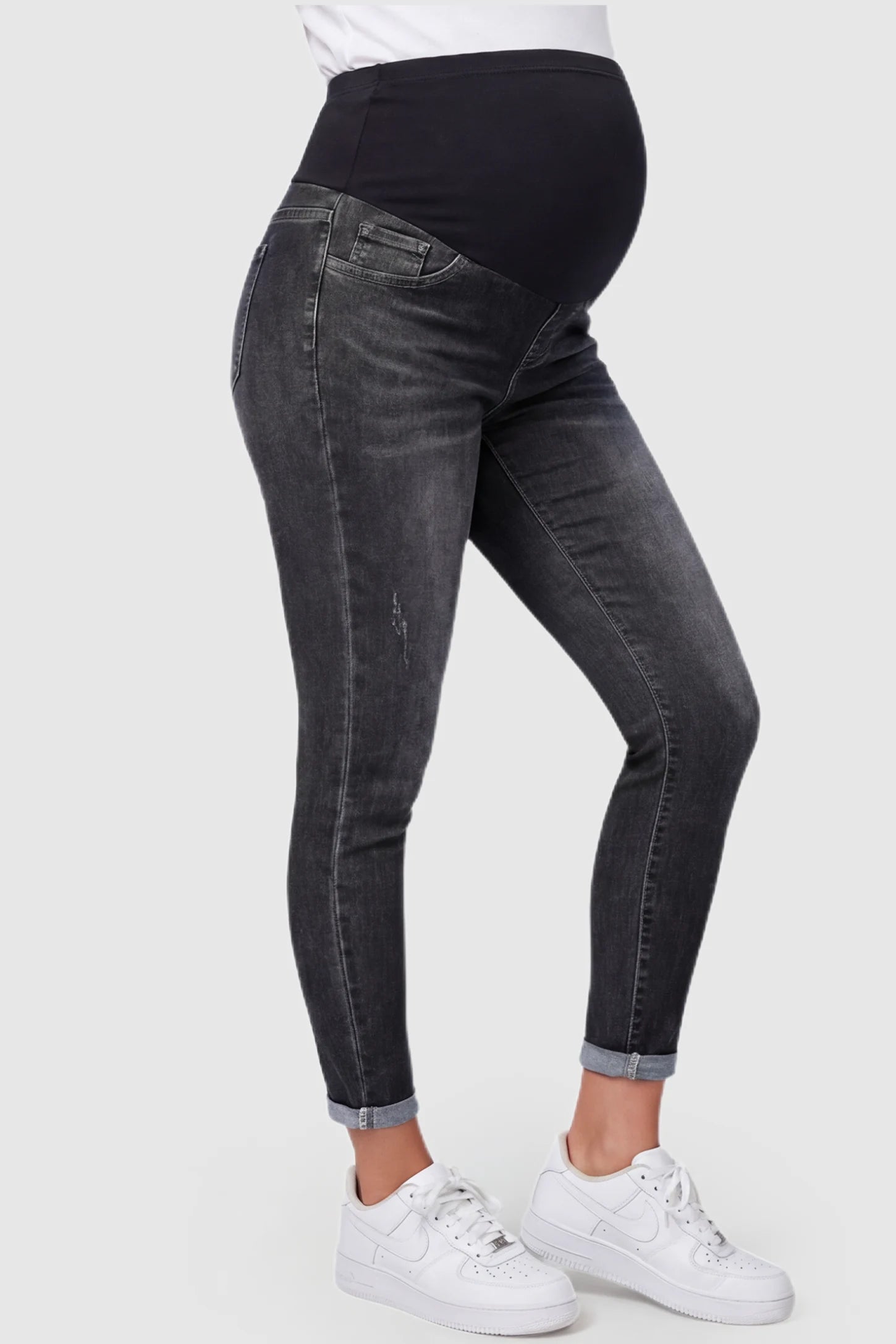 Cuffed Hem Skinny Maternity Jeans Cuffed Hem Skinny Maternity Jeans in black featuring full belly panel and ankle-length cuffed hem on pregnant model.
