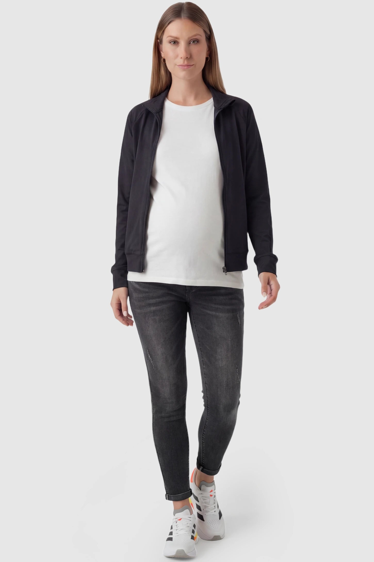 Cuffed Hem Skinny Maternity Jeans Cuffed Hem Skinny Maternity Jeans in black featuring full belly panel and ankle-length cuffed hem on pregnant model.