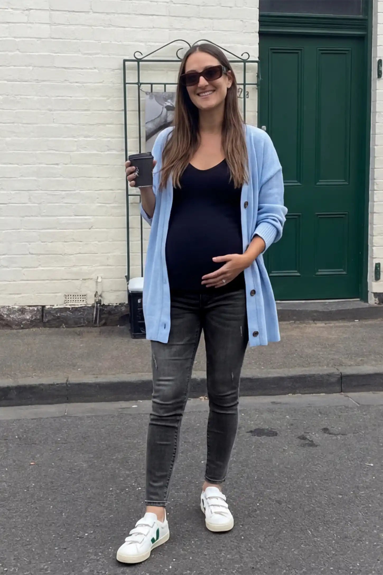 Cuffed Hem Skinny Maternity Jeans Cuffed Hem Skinny Maternity Jeans in black featuring full belly panel and ankle-length cuffed hem on front  view pregnant model.