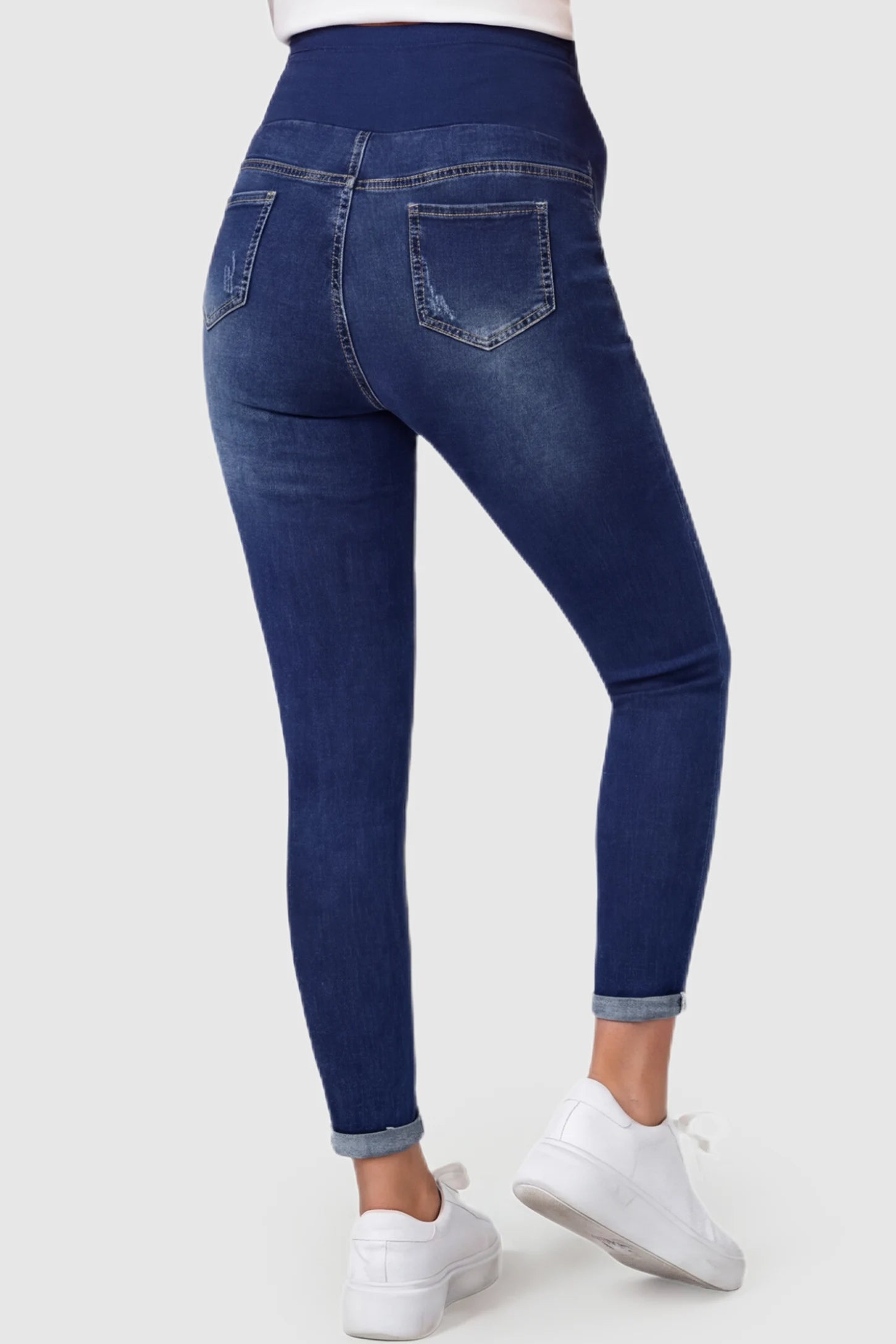 Cuffed Hem Skinny Maternity Jeans Cuffed Hem Skinny Maternity Jeans in dark blue featuring back pockets and ankle-length cuffed hem on pregnant model.