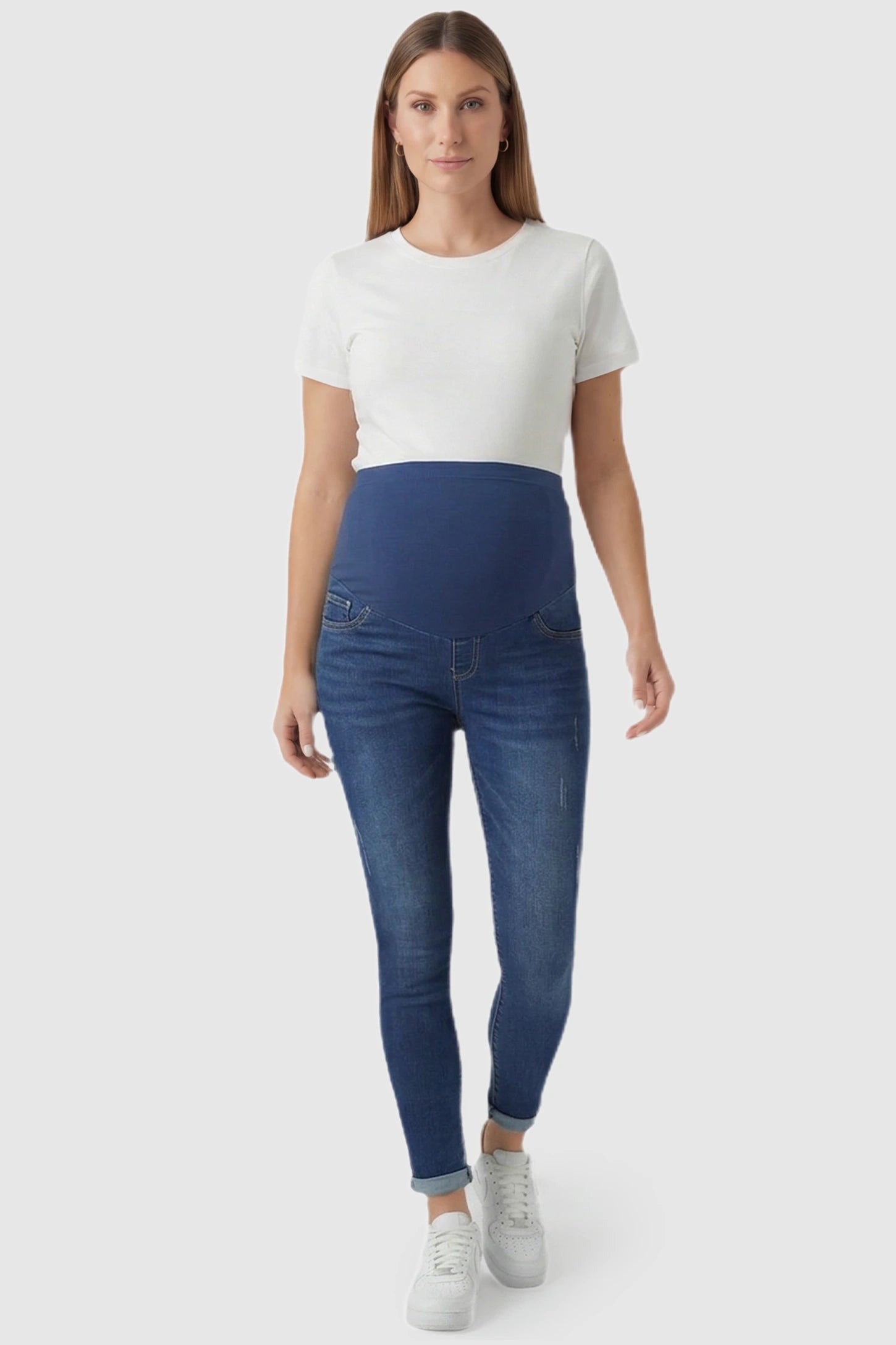Cuffed Hem Skinny Maternity Jeans Cuffed Hem Skinny Maternity Jeans in dark blue featuring full belly panel and ankle-length cuffed hem on pregnant model.
