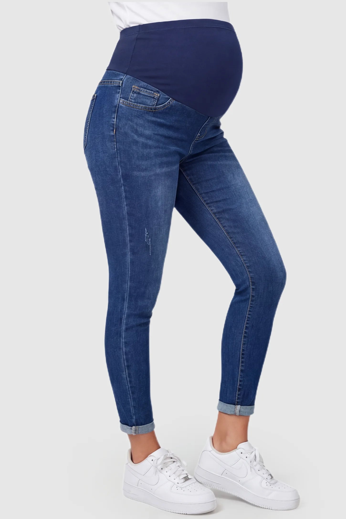 Cuffed Hem Skinny Maternity Jeans Cuffed Hem Skinny Maternity Jeans in dark blue featuring full belly panel and ankle-length cuffed hem on pregnant model.