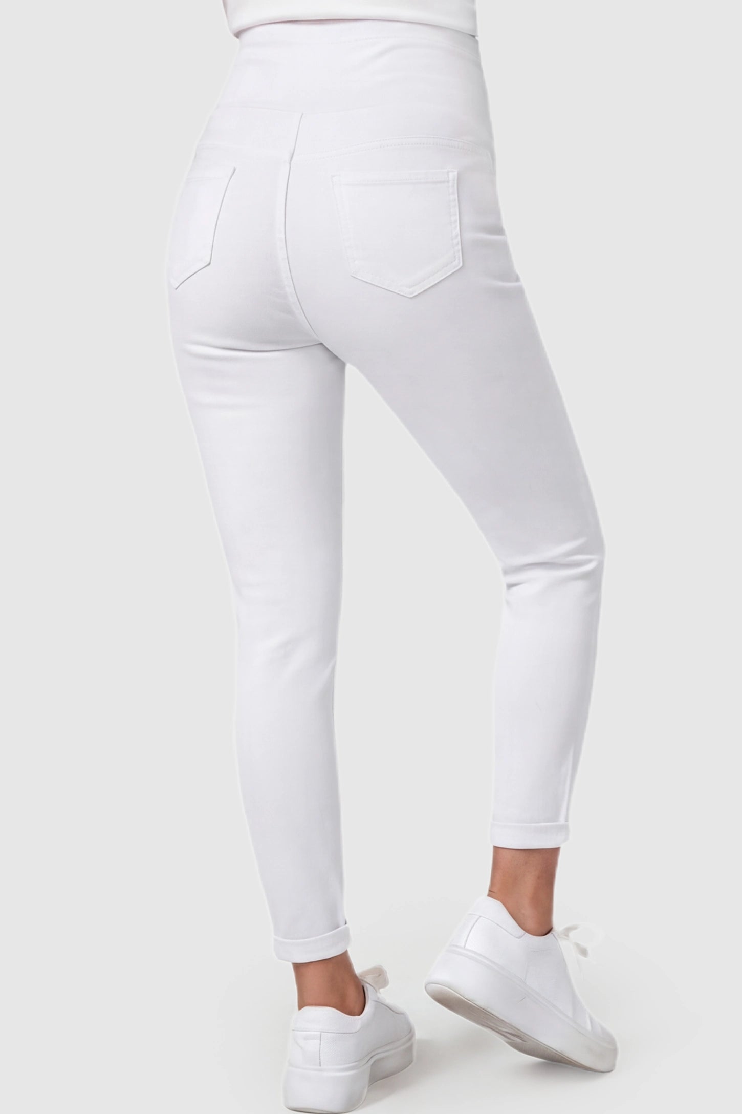 Cuffed Hem Skinny Maternity Jeans Cuffed Hem Skinny Maternity Jeans in White featuring back pockets and ankle-length cuffed hem on pregnant model.