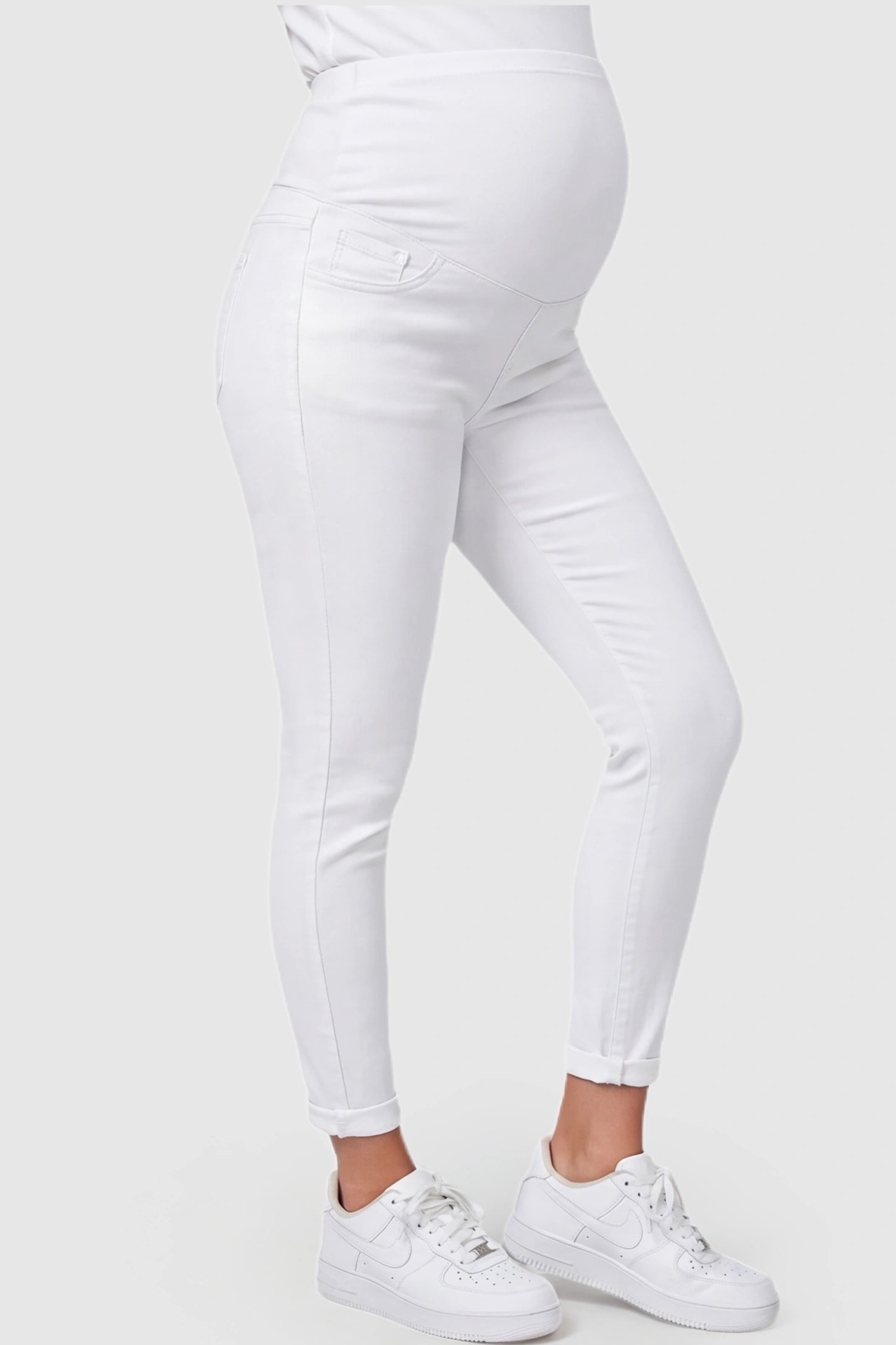 Cuffed Hem Skinny Maternity Jeans Cuffed Hem Skinny Maternity Jeans in White featuring full belly panel and ankle-length cuffed hem on pregnant model.