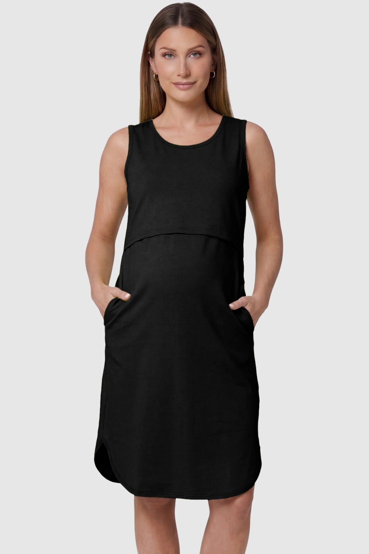 Sleeveless High-Waisted Midi Maternity & Nursing Dress Sleeveless high-waisted midi maternity and nursing dress in black featuring functional side pockets in front view on a pregnant model