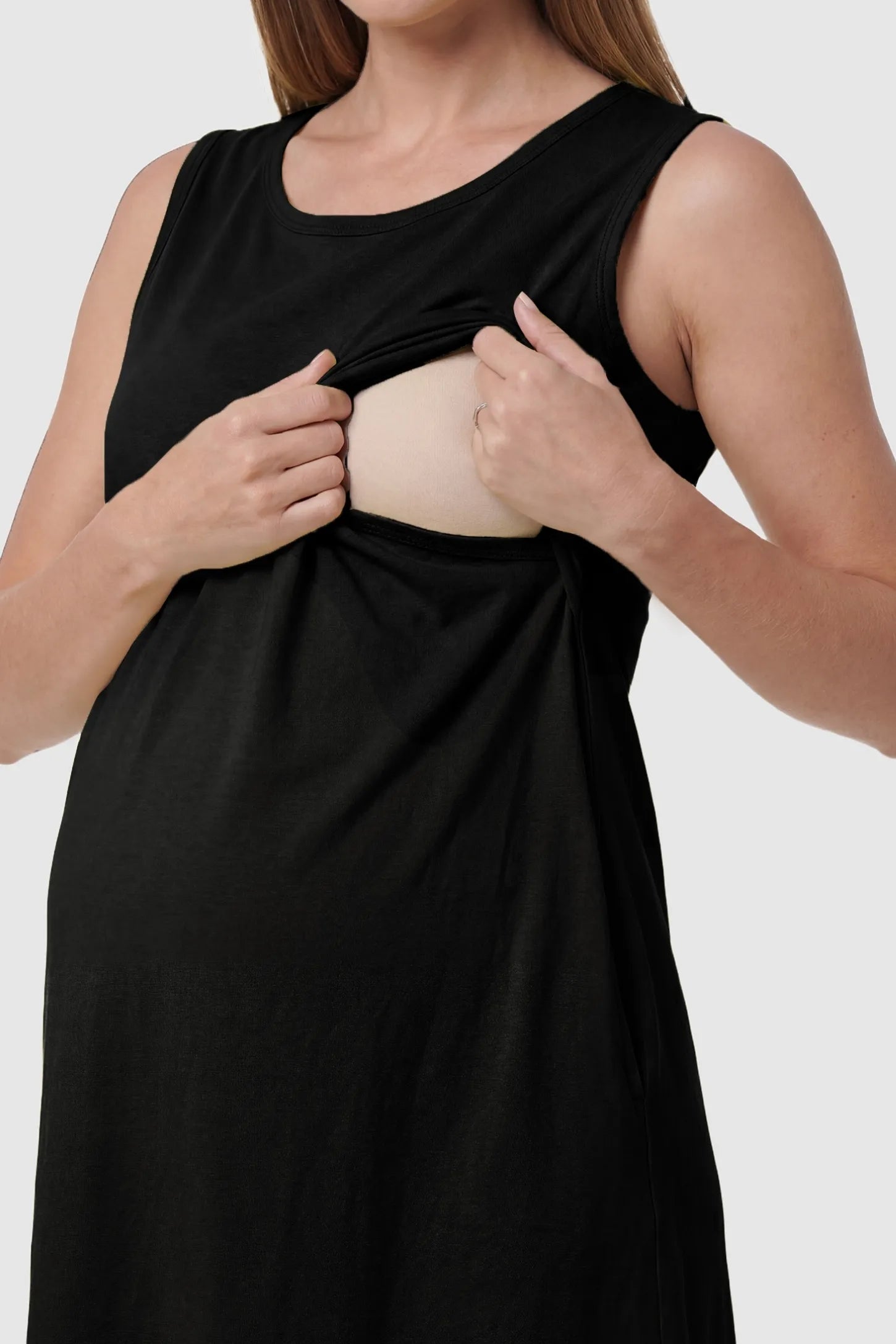 Sleeveless High-Waisted Midi Maternity & Nursing Dress Sleeveless high-waisted midi maternity and nursing dress in black featuring discreet nursing access in front view on a pregnant model