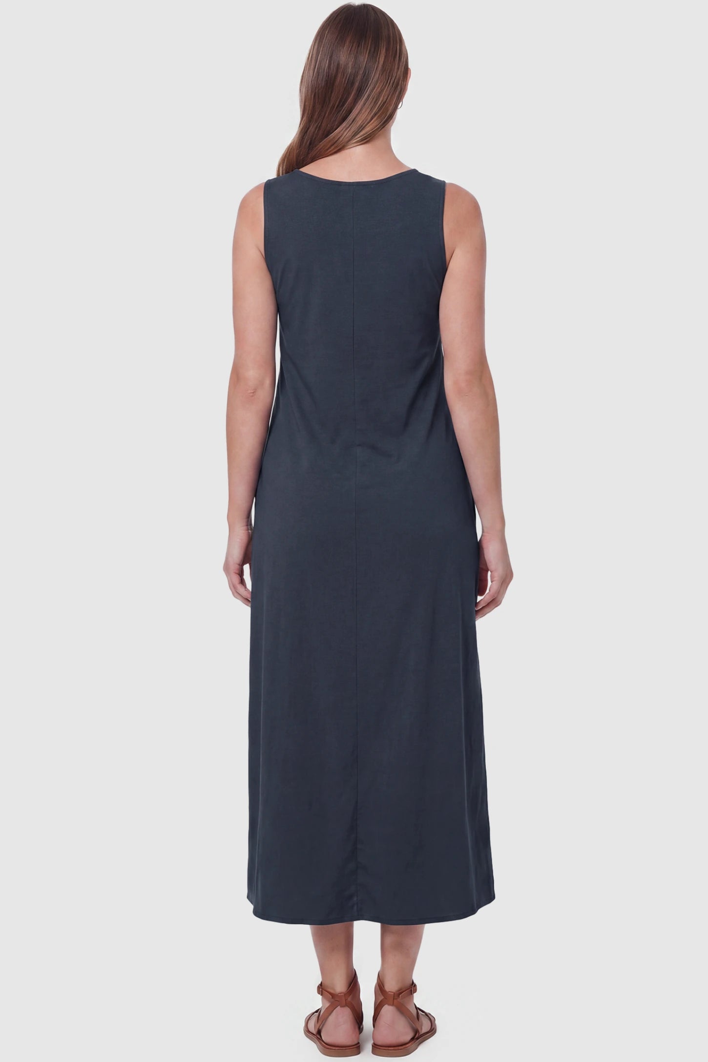 Sleeveless Pocketed Longline Hem Maternity Midi Dress Sleeveless pocketed longline hem maternity midi dress in dark blue with sleeveless design and longline hem, back view on pregnant model