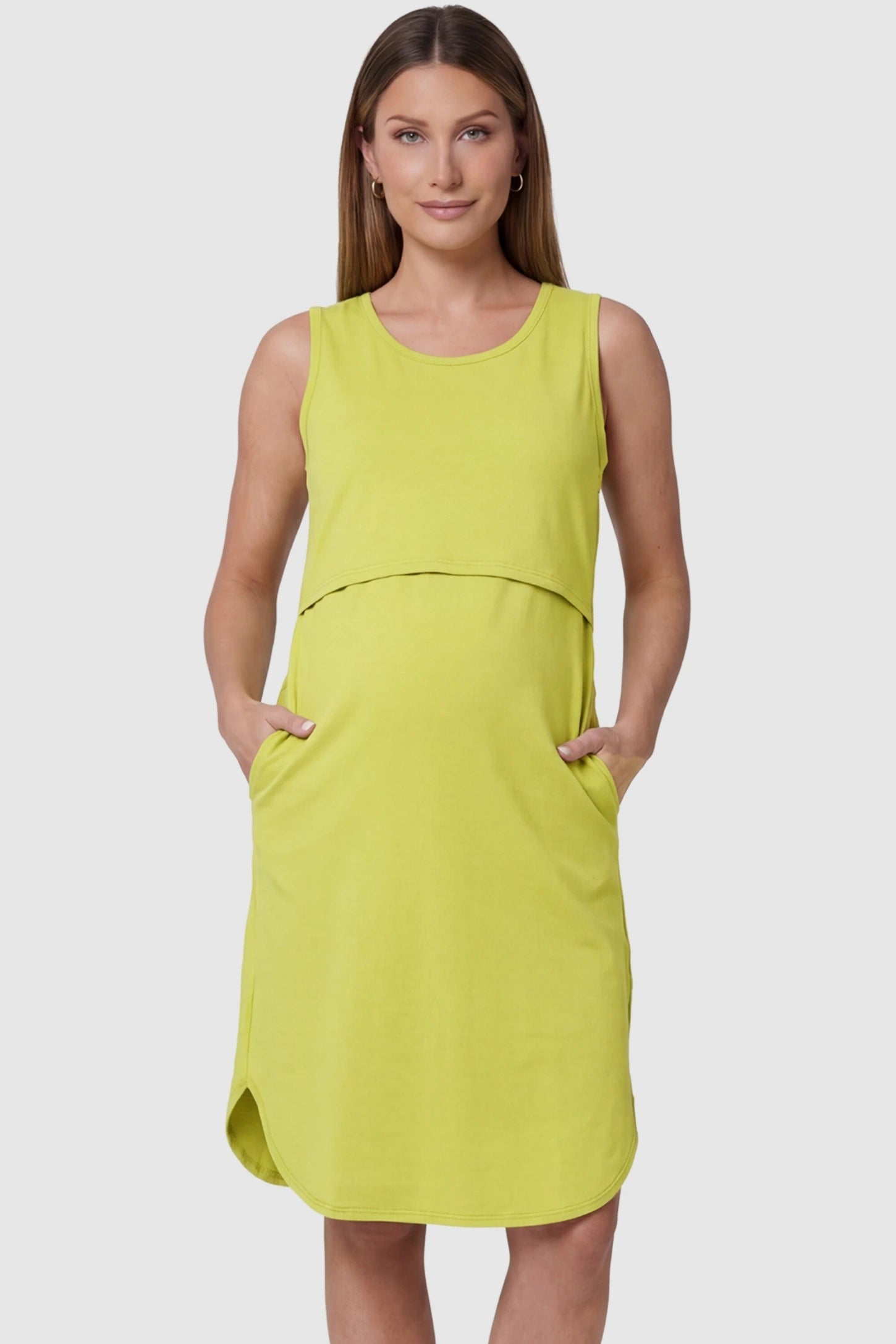 Sleeveless High-Waisted Midi Maternity & Nursing Dress Sleeveless high-waisted midi maternity and nursing dress in ginger yellow featuring functional side pockets in front view on a pregnant model