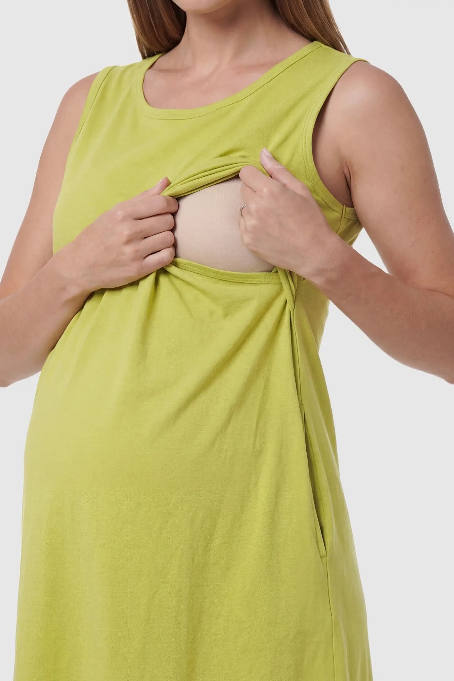 Sleeveless High-Waisted Midi Maternity & Nursing Dress Sleeveless high-waisted midi maternity and nursing dress in ginger yellow featuring discreet nursing access in front view on a pregnant model