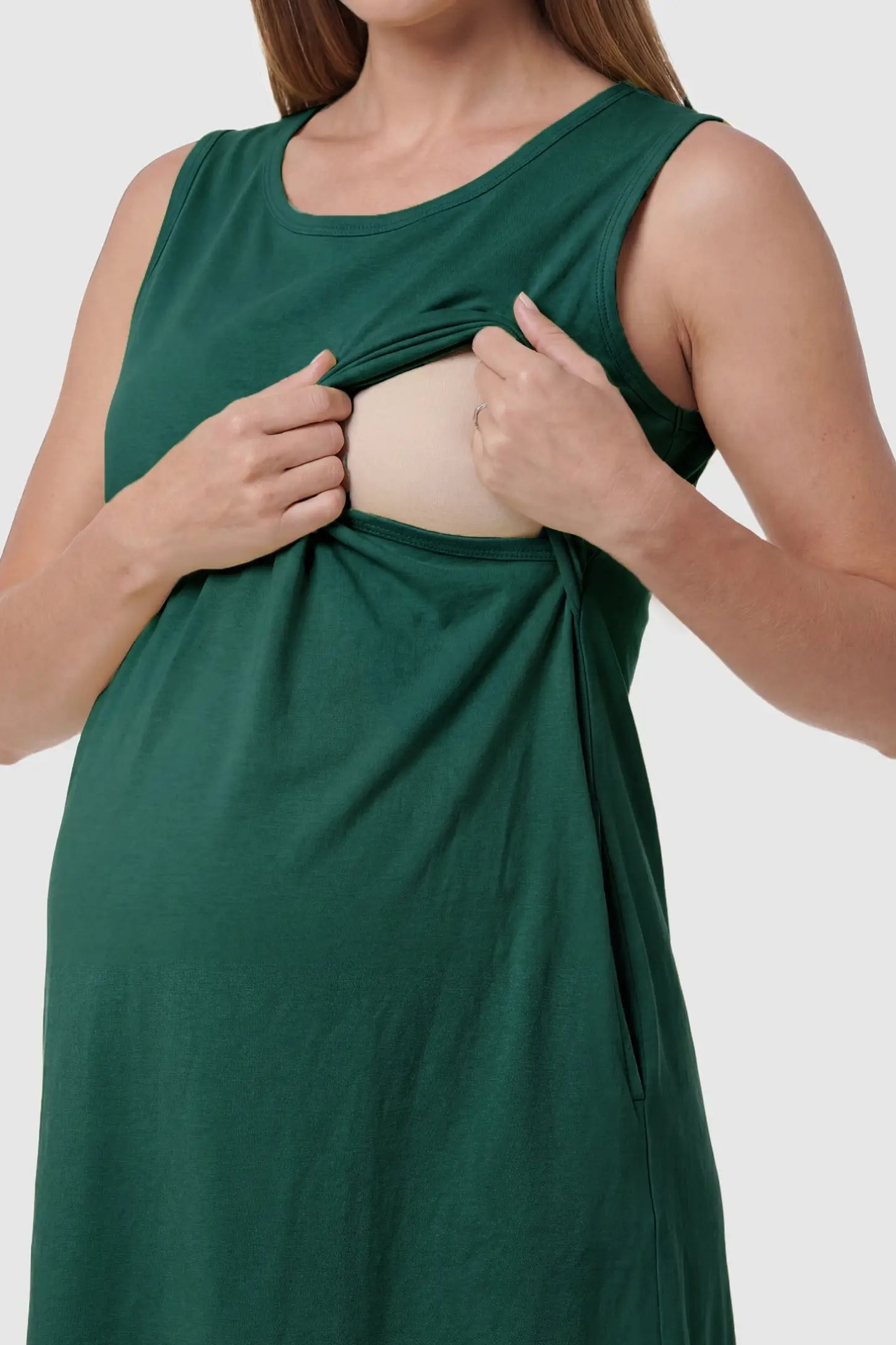 Sleeveless High-Waisted Midi Maternity & Nursing Dress Sleeveless high-waisted midi maternity and nursing dress in green featuring discreet nursing access in front view on a pregnant model
