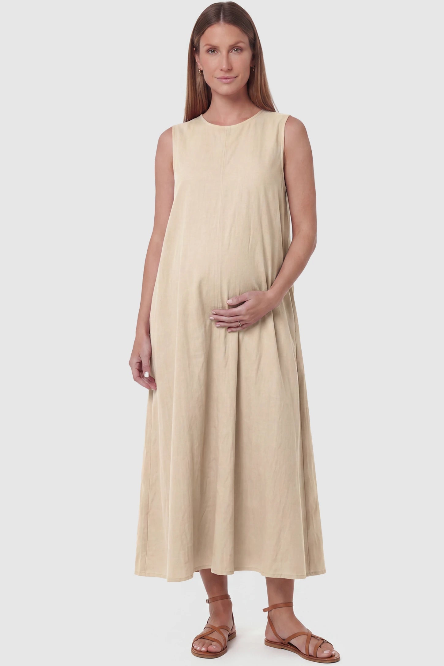 Sleeveless Pocketed Longline Hem Maternity Midi Dress Sleeveless pocketed longline hem maternity midi dress in khaki with sleeveless design and longline hem, front view on pregnant model