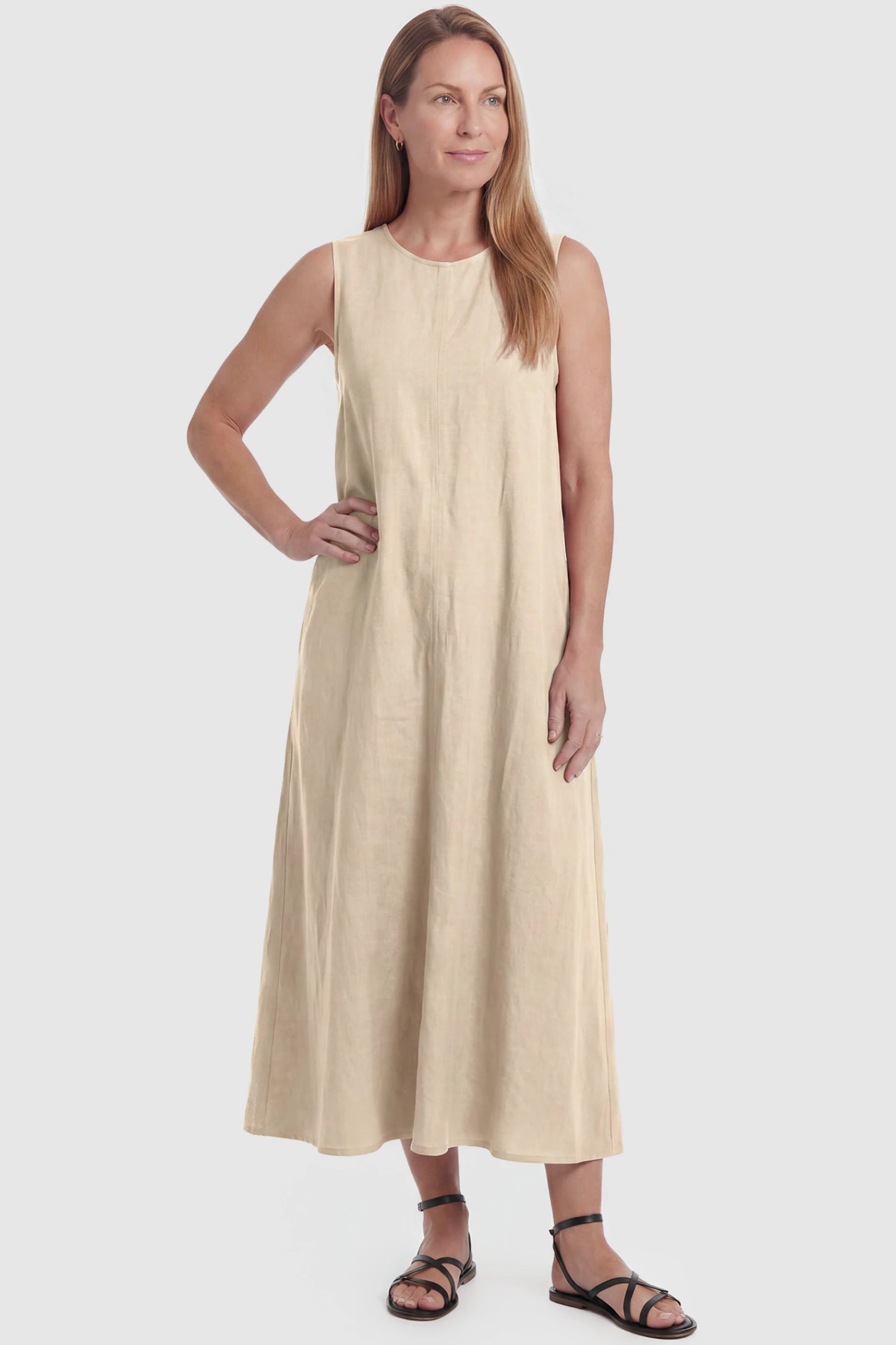 Sleeveless Pocketed Longline Hem Maternity Midi Dress Sleeveless pocketed longline hem maternity midi dress in khaki with sleeveless design and longline hem, front view on postpartum model