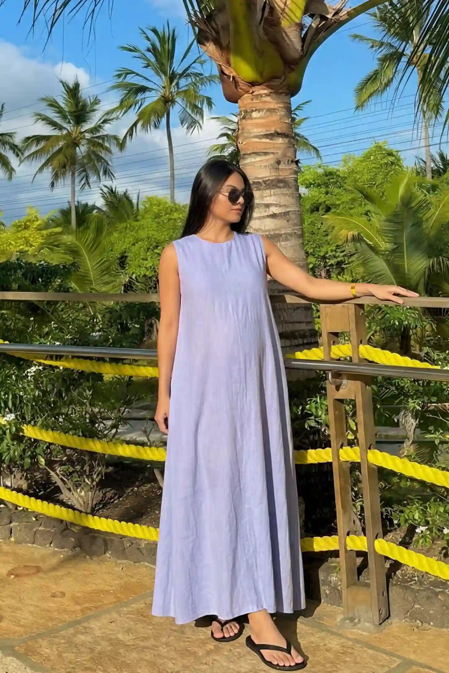 Sleeveless Pocketed Longline Hem Maternity Midi Dress Sleeveless pocketed longline hem maternity midi dress in light blue with sleeveless design and longline hem, front view on pregnant model