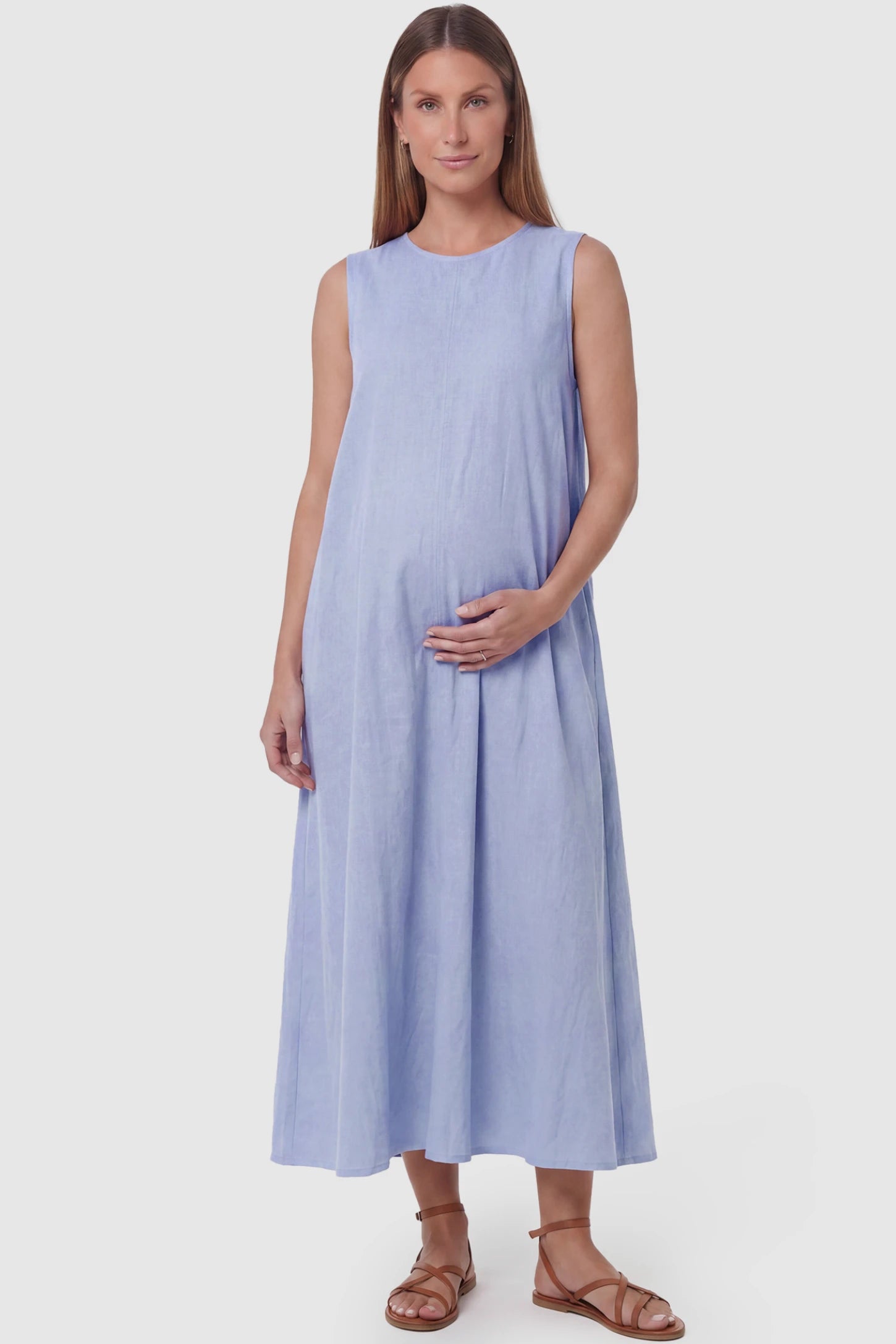 Sleeveless Pocketed Longline Hem Maternity Midi Dress Sleeveless pocketed longline hem maternity midi dress in light blue with sleeveless design and longline hem, front view on pregnant model