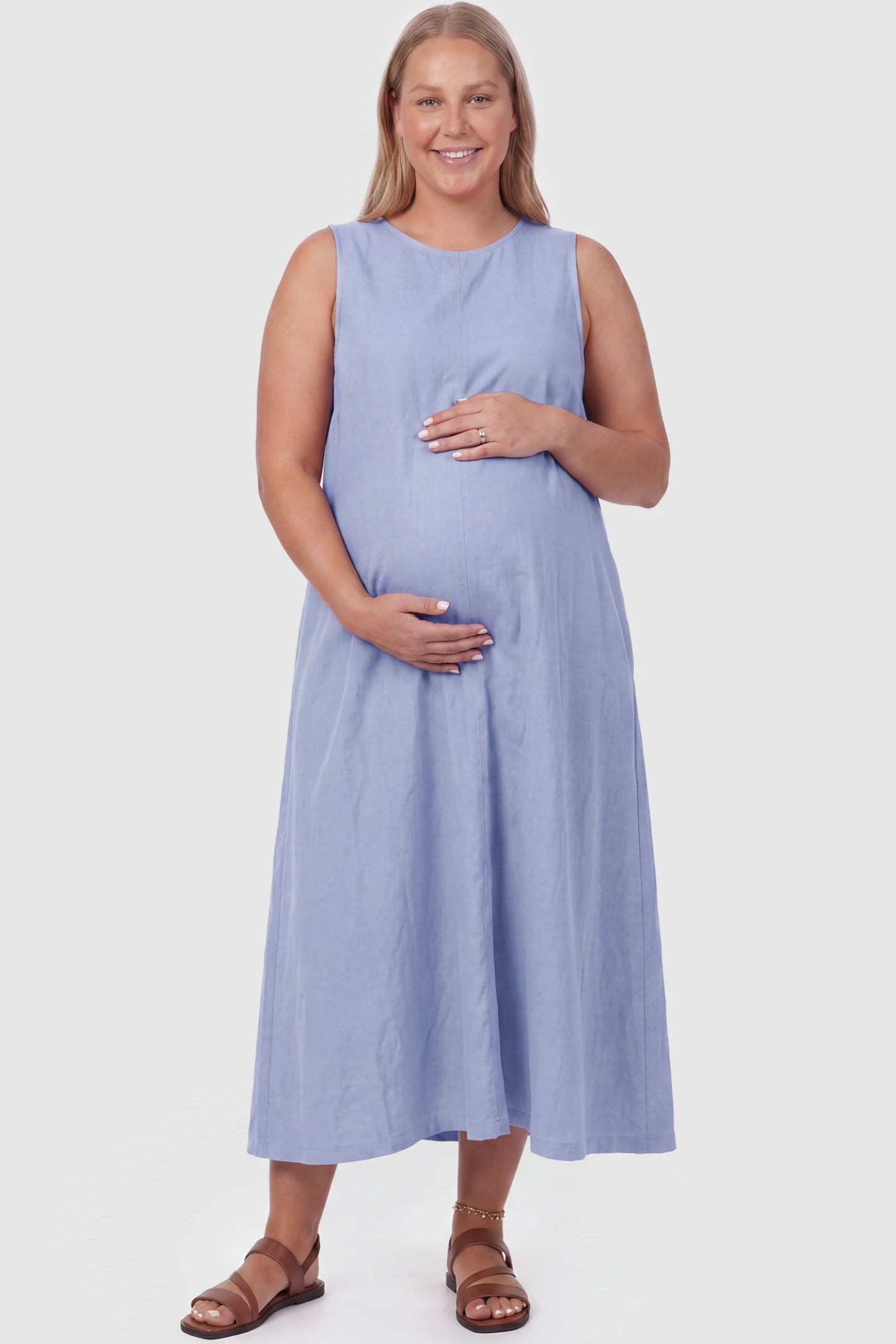 Sleeveless Pocketed Longline Hem Maternity Midi Dress Sleeveless pocketed longline hem maternity midi dress in light blue with sleeveless design and longline hem, front view on plus-size model