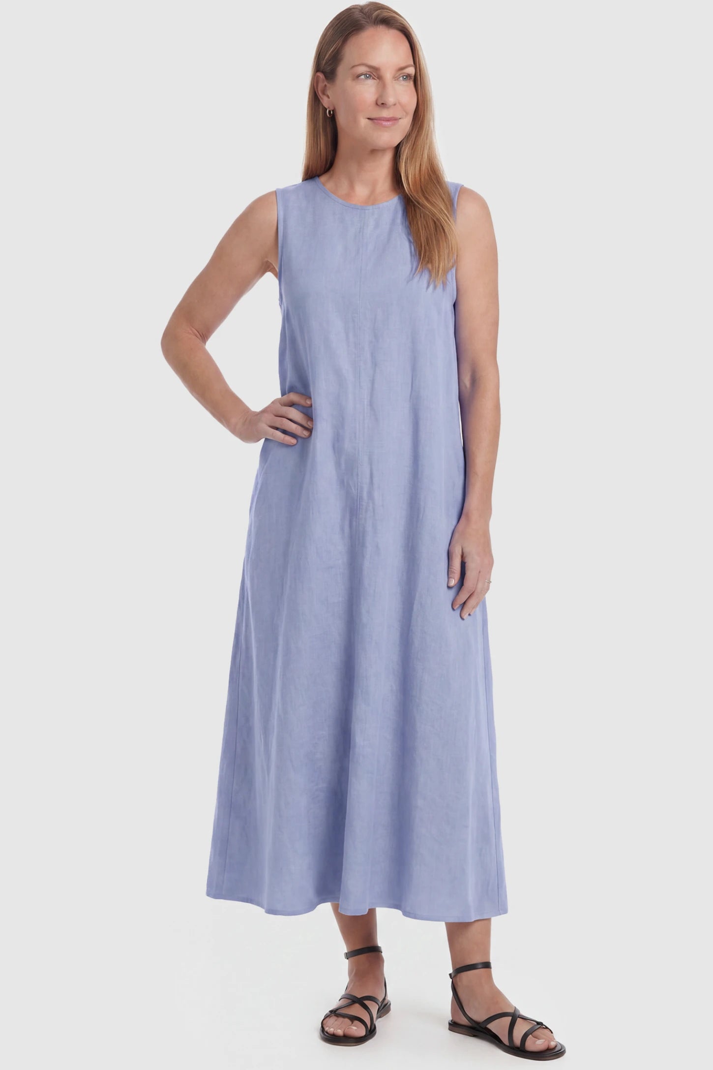 Sleeveless Pocketed Longline Hem Maternity Midi Dress Sleeveless pocketed longline hem maternity midi dress in light blue with sleeveless design and longline hem, front view on postpartum model