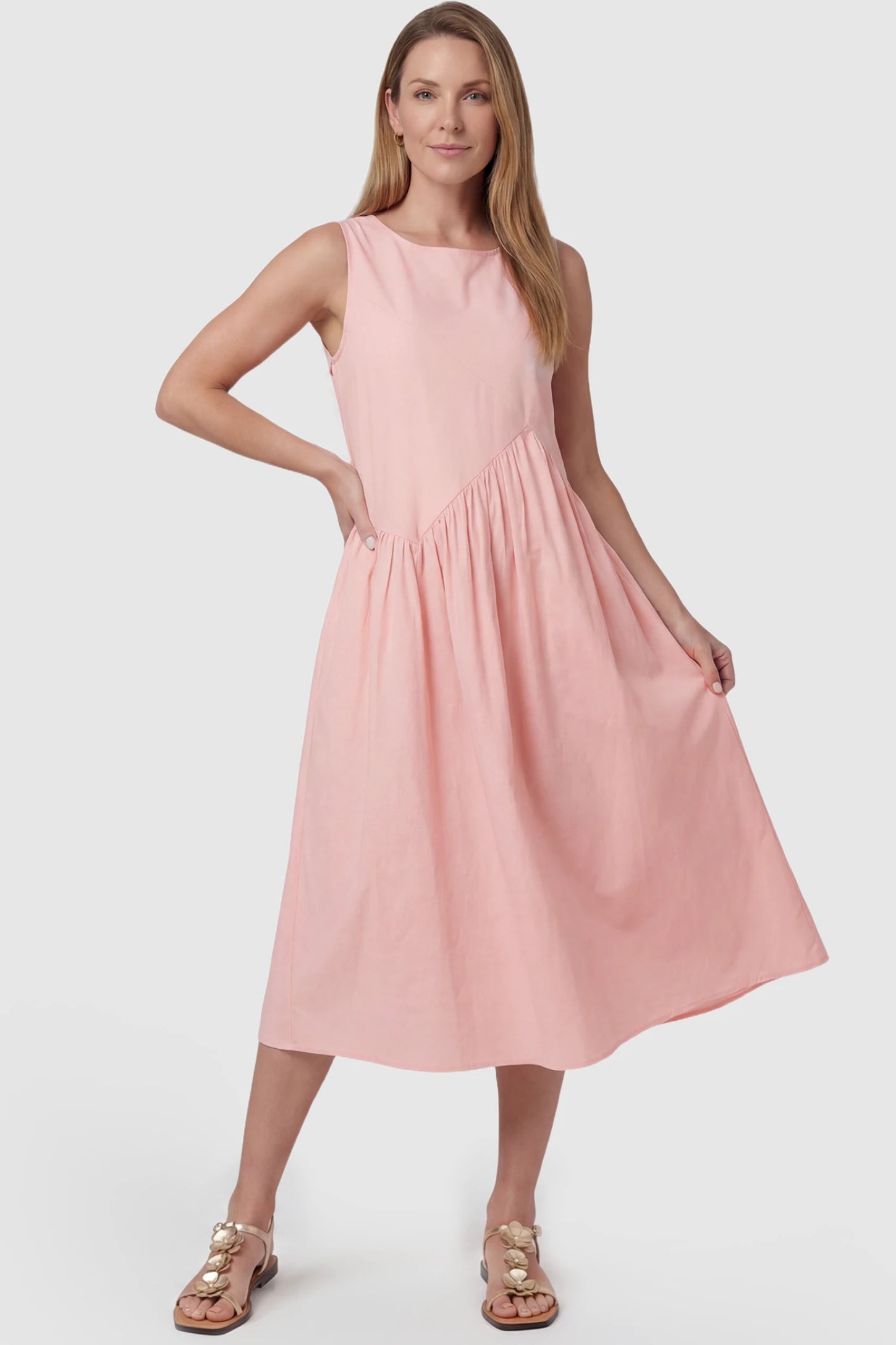 Sleeveless A-Line Maternity Midi Dress with Pockets Sleeveless A-line maternity midi dress with pockets in pink with sleeveless design and soft drape, front view on postpartum model