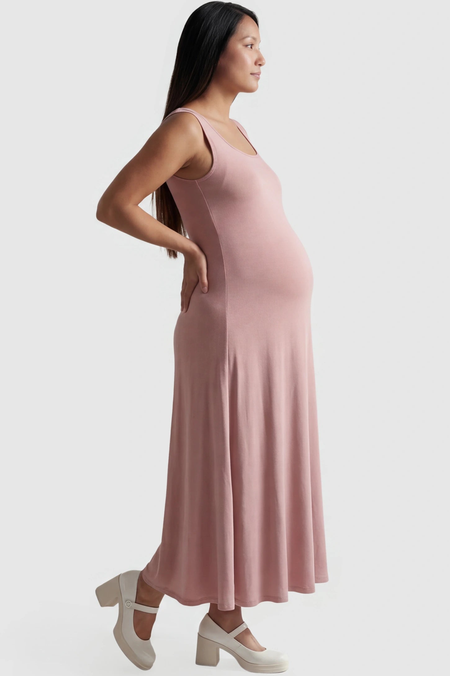 Square Neck Sleeveless Maternity Maxi Dress Square neck sleeveless maternity maxi dress in pink with sleeveless design, side view on pregnant model