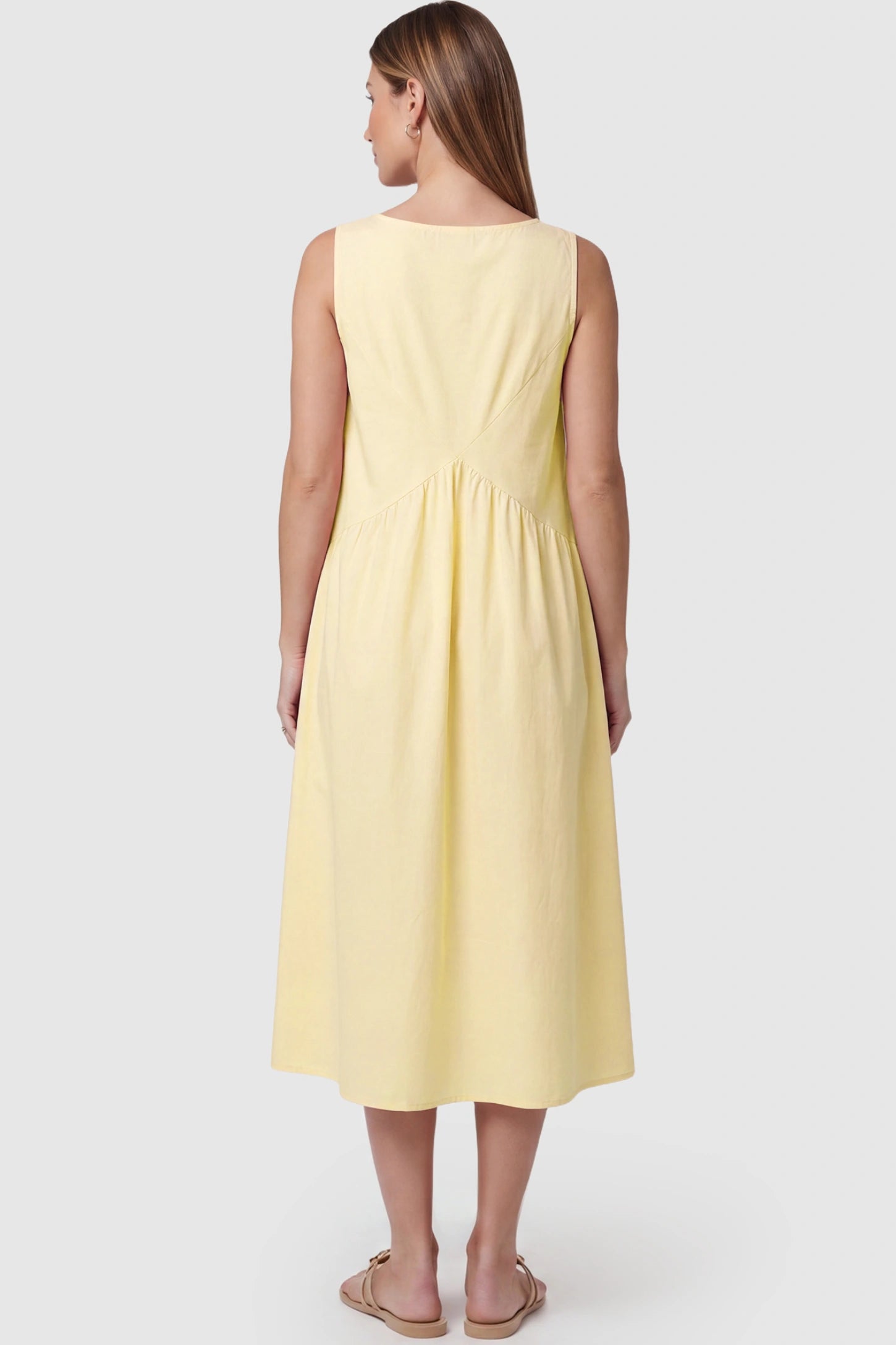 Sleeveless A-Line Maternity Midi Dress with Pockets Sleeveless A-line maternity midi dress with pockets in yellow with sleeveless design and soft drape, back view on pregnant model