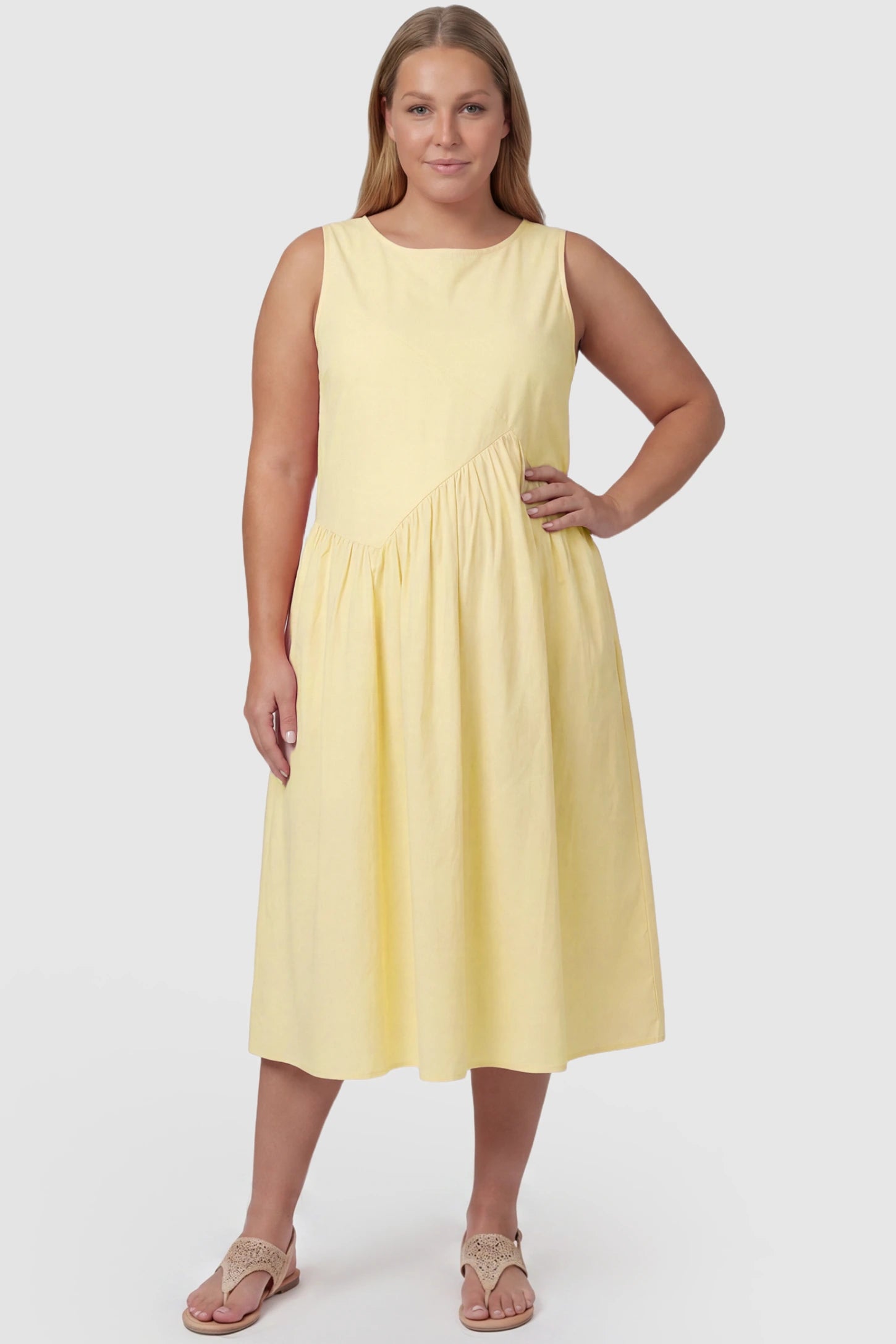 Sleeveless A-Line Maternity Midi Dress with Pockets Sleeveless A-line maternity midi dress with pockets in yellow with sleeveless design and soft drape, front view on plus-size model