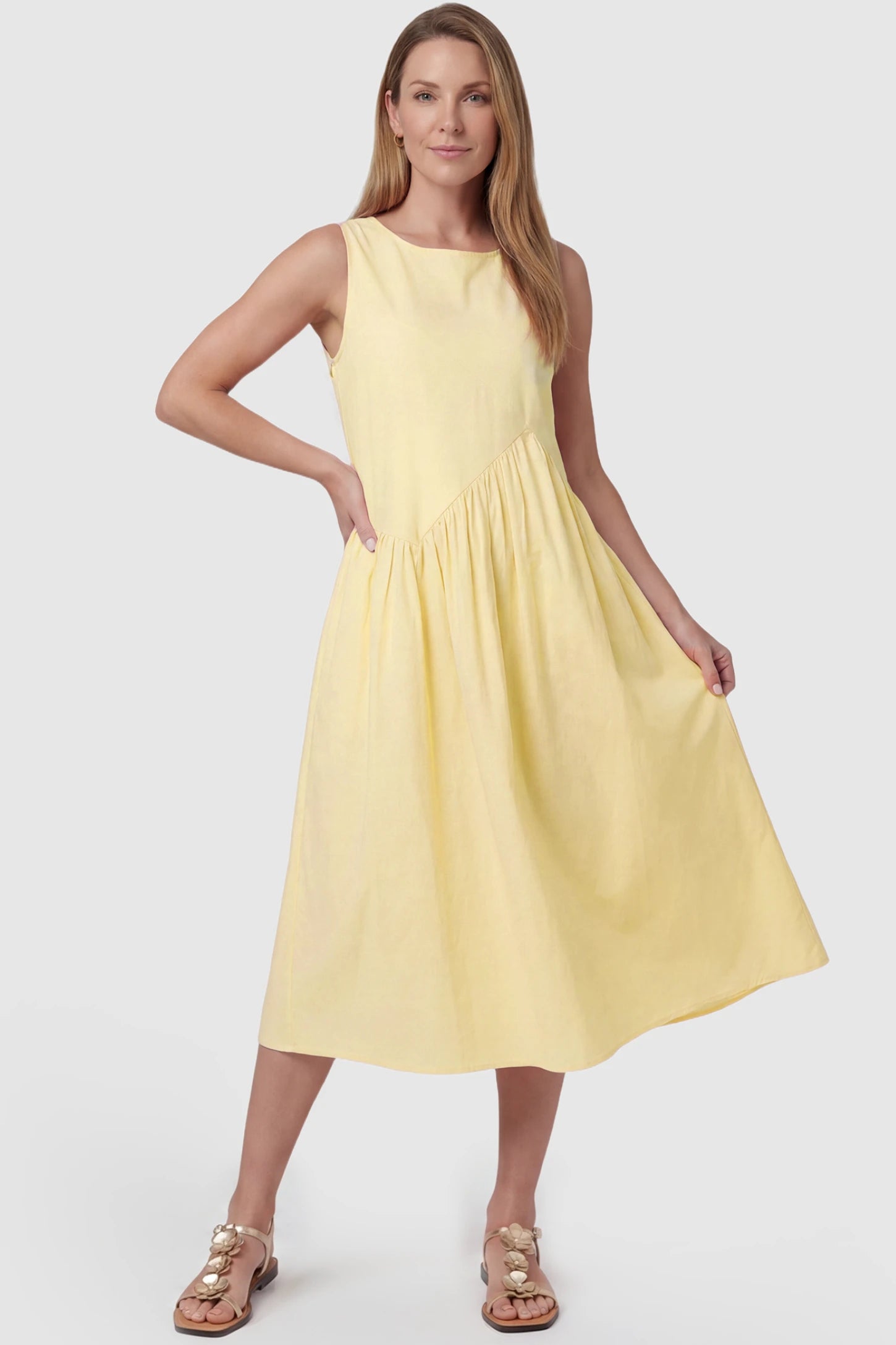 Sleeveless A-Line Maternity Midi Dress with Pockets Sleeveless A-line maternity midi dress with pockets in yellow with sleeveless design and soft drape, front view on postpartum model