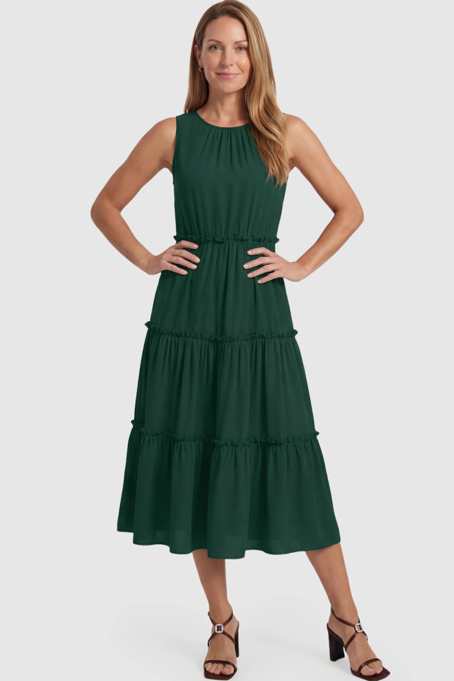Solid Sleeveless Ruffle Tiered Maternity Midi Dress Solid Sleeveless Ruffle Tiered Maternity Midi Dress in dark green featuring a ruffle tiered skirt on a postpartum model.