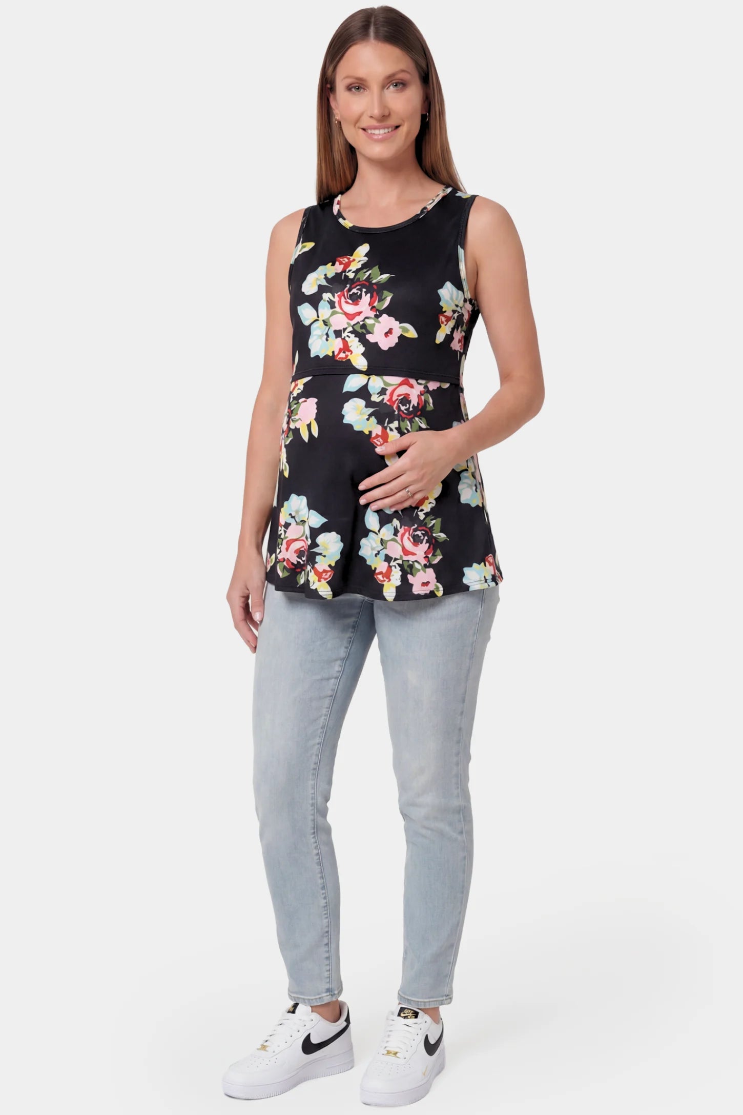 Floral Round Neck Maternity & Nursing Top Floral Round Neck Maternity & Nursing Top in black floral print featuring a sleeveless A-line silhouette on a pregnant model.