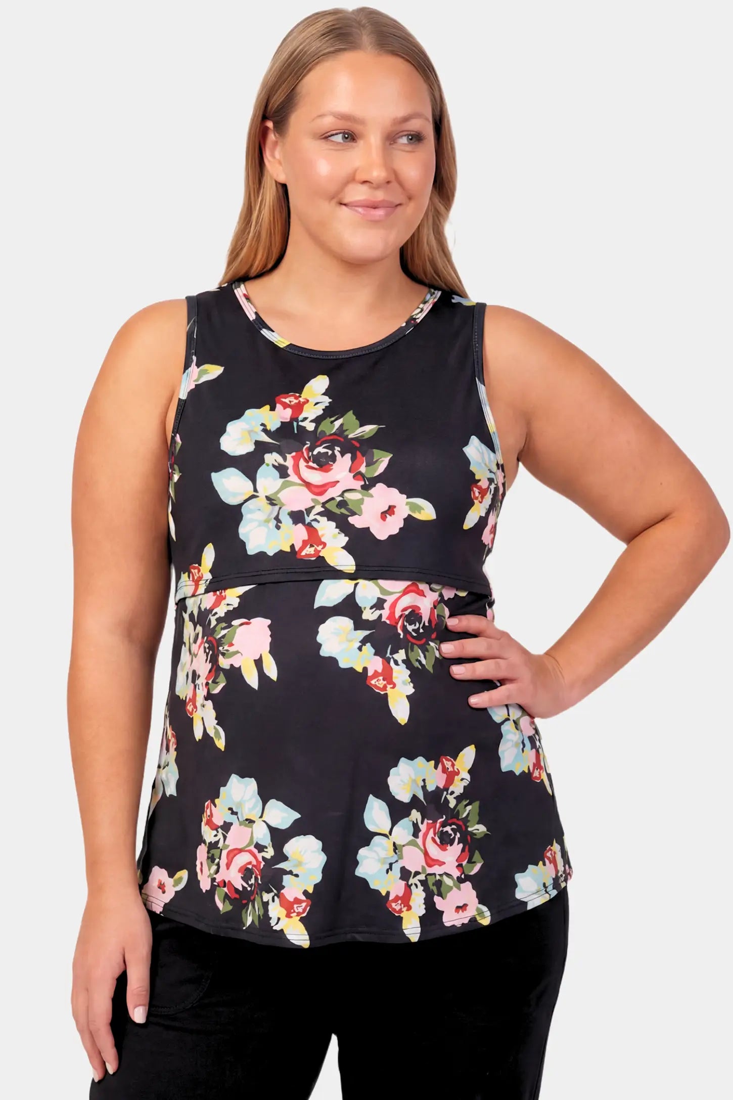 Floral Round Neck Maternity & Nursing Top Floral Round Neck Maternity & Nursing Top in black floral print featuring a sleeveless A-line silhouette on a pregnant model.