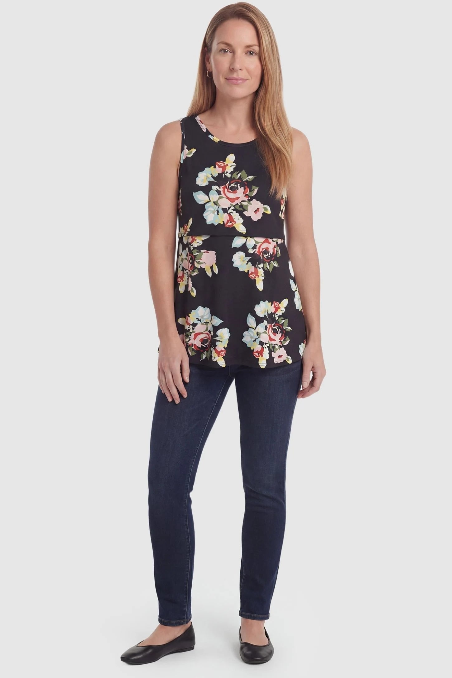 Floral Round Neck Maternity & Nursing Top Floral Round Neck Maternity & Nursing Top in black floral print featuring a sleeveless A-line silhouette on a pregnant model. front view