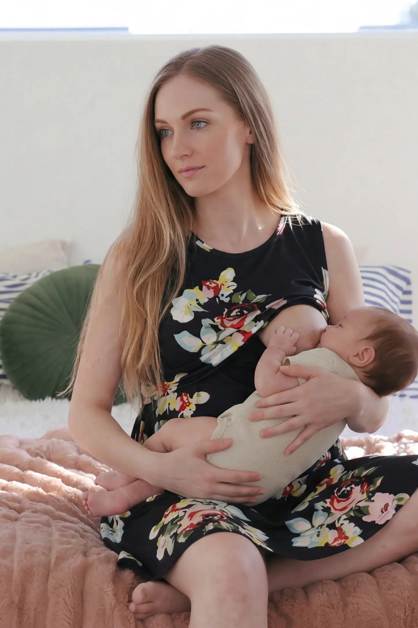 Floral Round Neck Maternity & Nursing Top Floral Round Neck Maternity & Nursing Top in black floral print featuring an easy nursing access, front view on a non pregnant model.