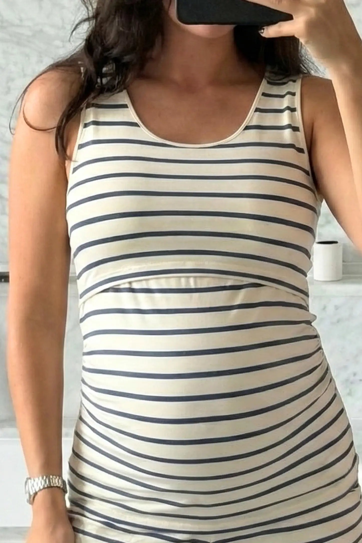 Concealed Nursing Opening Sleeveless Maternity & Nursing Top Concealed Nursing Opening Sleeveless Maternity & Nursing Top in Blue and White Stripes featuring a sleeveless cut and hidden nursing access shown in front view on a UGC pregnant model.