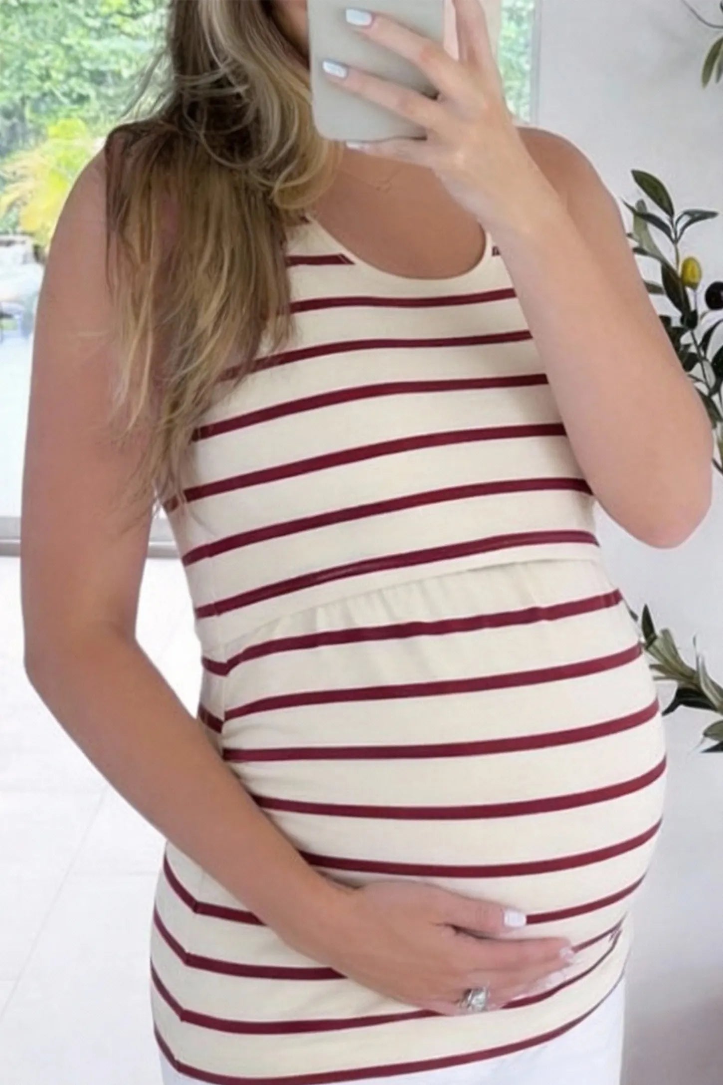 Concealed Nursing Opening Sleeveless Maternity & Nursing Top Concealed Nursing Opening Sleeveless Maternity & Nursing Top in Red and White Stripes featuring a sleeveless cut and hidden nursing access shown in front view on a UGC pregnant model.