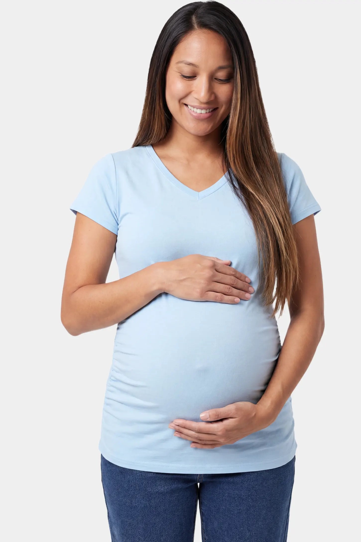 Slim fit V-neck short sleeve maternity top in light blue featuring soft stretch fabric in front view on a pregnant model
