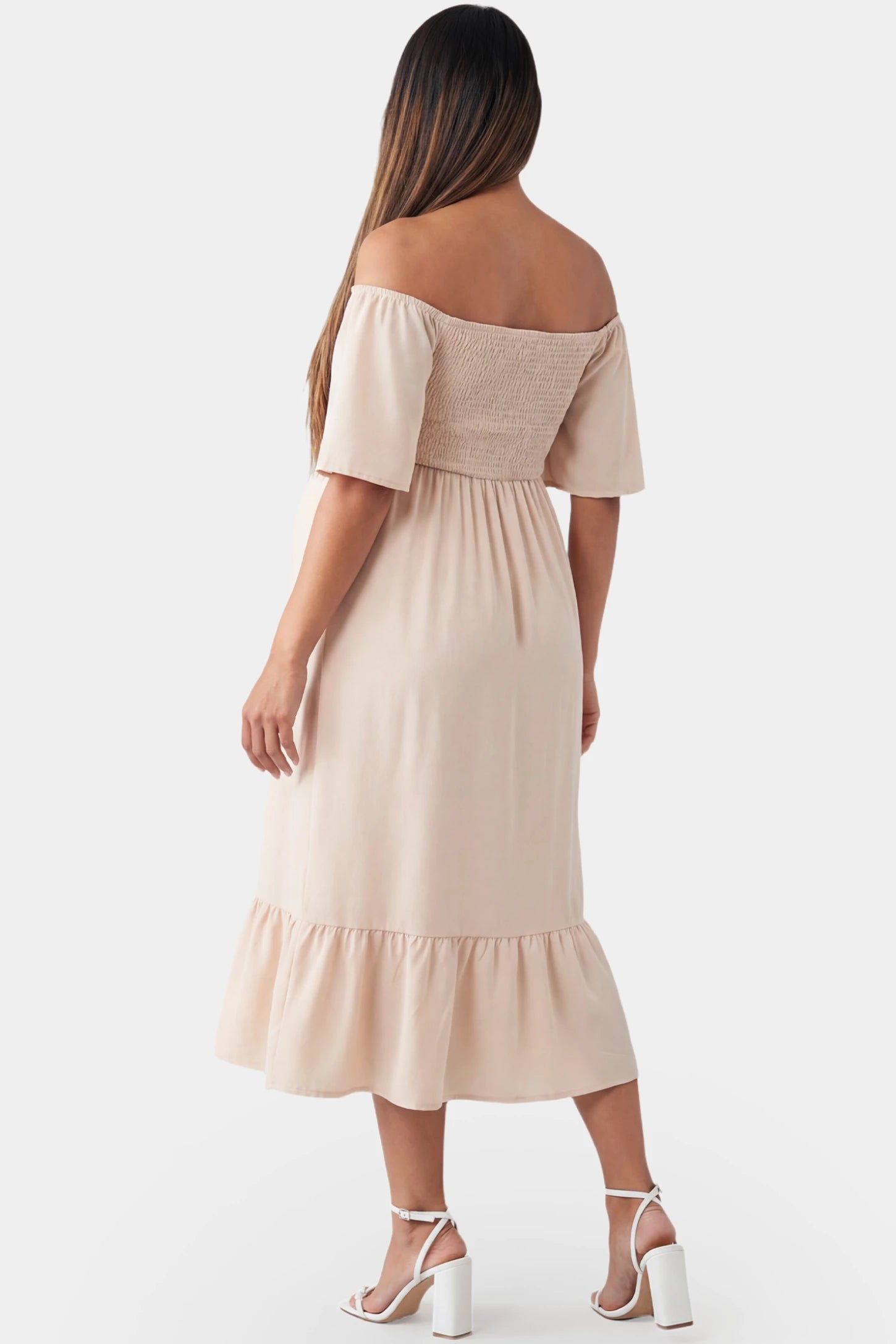 Off-Shoulder Smocked Short Sleeve A-Line Midi Maternity Dress Off-shoulder smocked short sleeve A-line midi maternity dress in apricot featuring chiffon drape in back view on a pregnant model