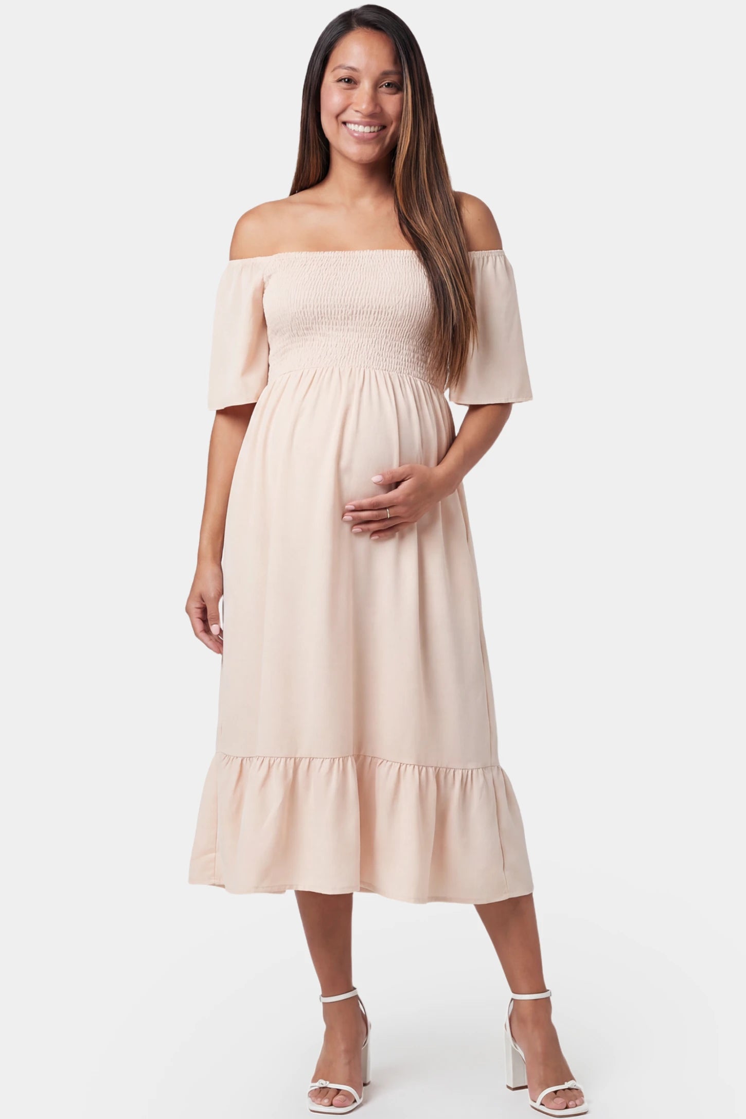 Off-Shoulder Smocked Short Sleeve A-Line Midi Maternity Dress Off-shoulder smocked short sleeve A-line midi maternity dress in apricot featuring smocked elastic waist in front view on a pregnant model