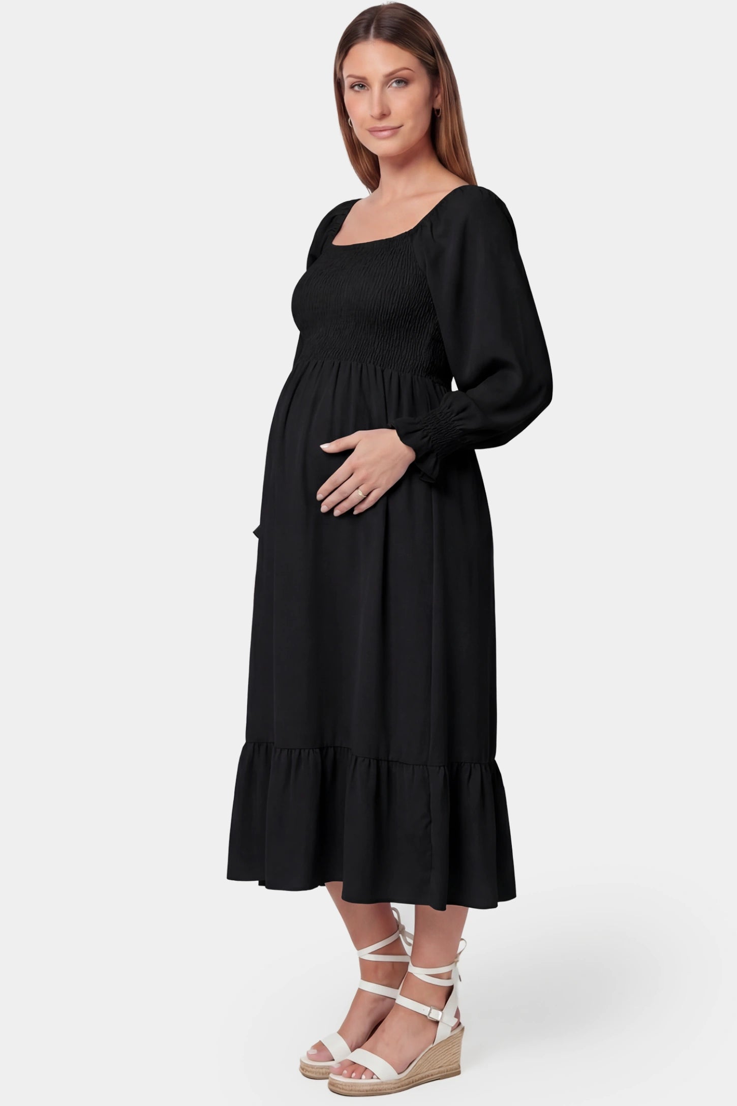Smocked Square Neck Ruffle Hem Midi Maternity Dress Smocked square neck ruffle hem midi maternity dress in black featuring smocked bodice in side view on a pregnant model