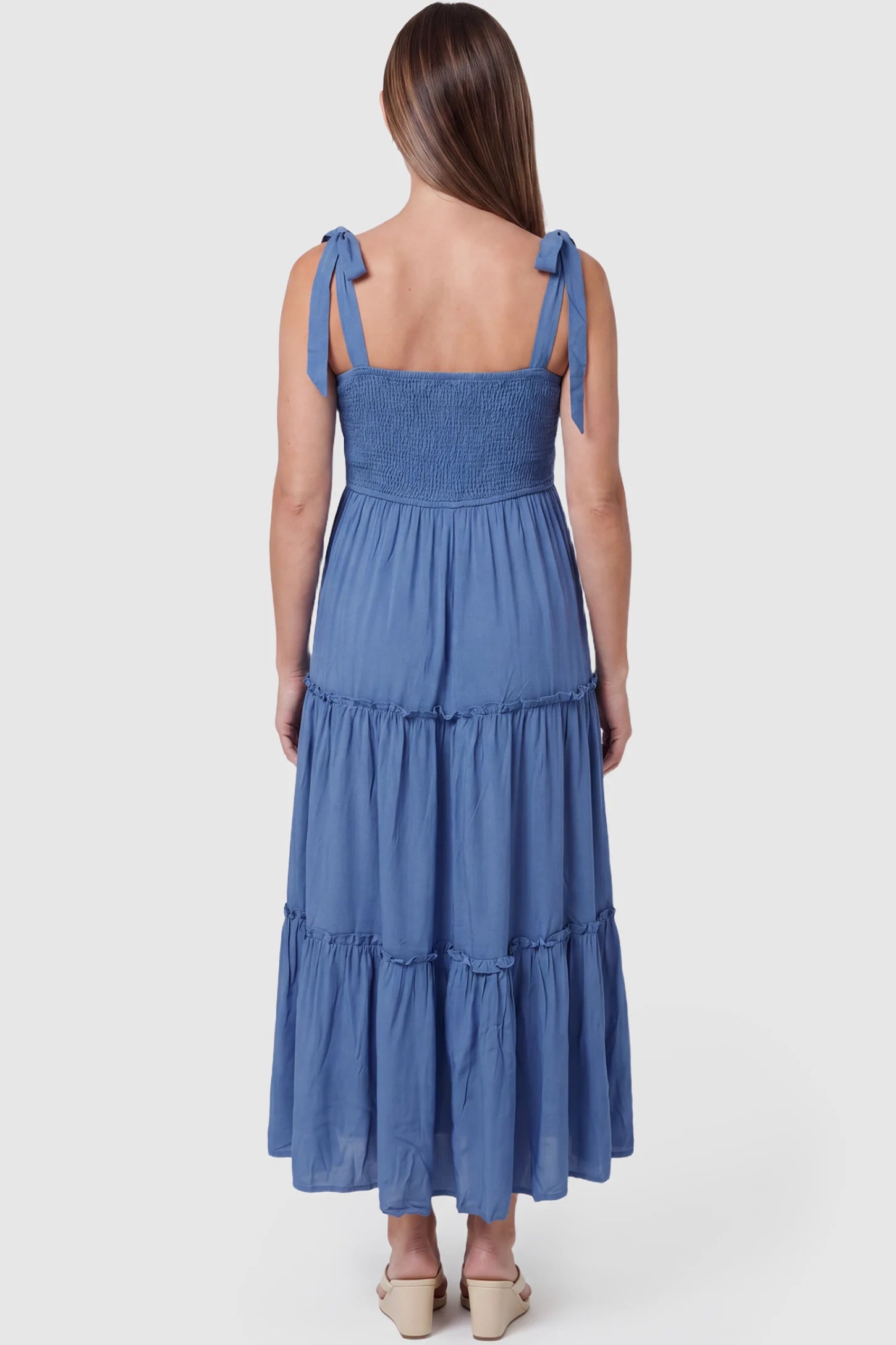 Smocked Square Neck Tiered Maternity Midi Dress Smocked square neck tiered maternity midi dress in blue with soft stretchy fabric and adjustable tie-back straps, back view on pregnant model