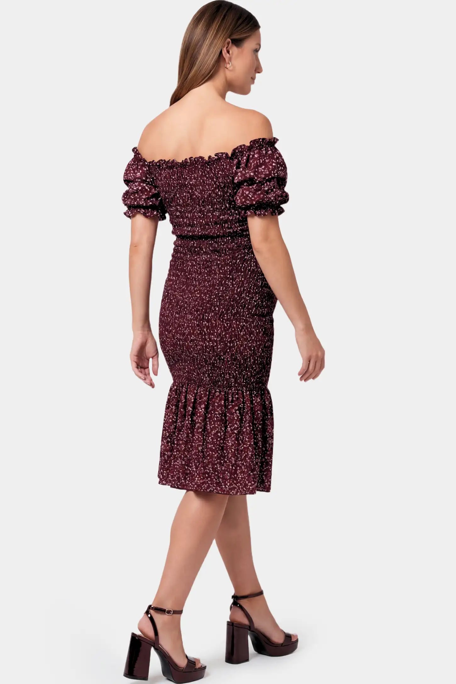 Short Puff Sleeve Smocked Maternity Midi Dress Short Puff Sleeve Smocked Maternity Midi Dress in burgundy floral featuring off shoulder neckline and ruffle hem on a pregnant model.