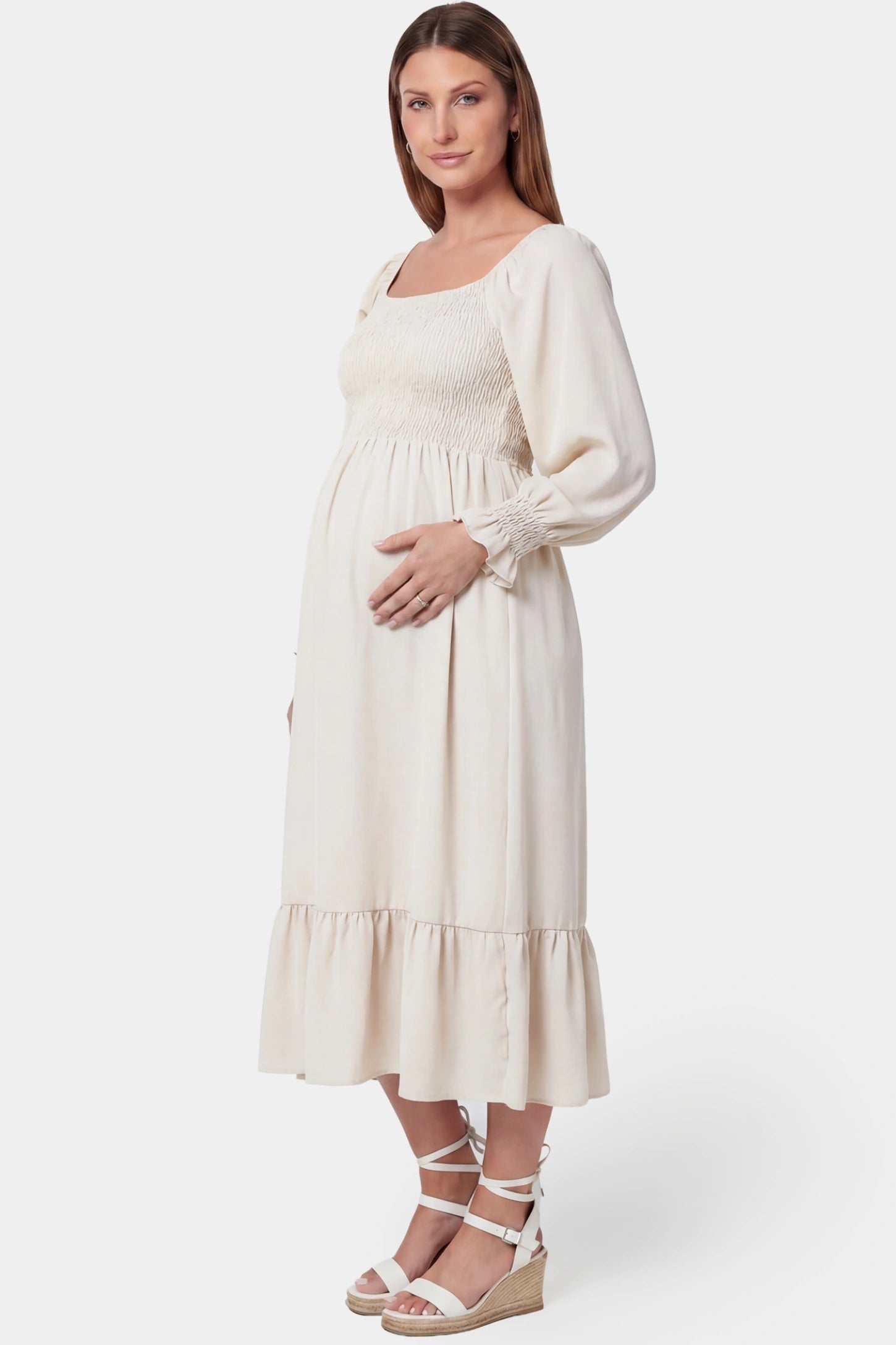 Smocked Square Neck Ruffle Hem Midi Maternity Dress Smocked square neck ruffle hem midi maternity dress in off-white featuring smocked bodice in side view on a pregnant model