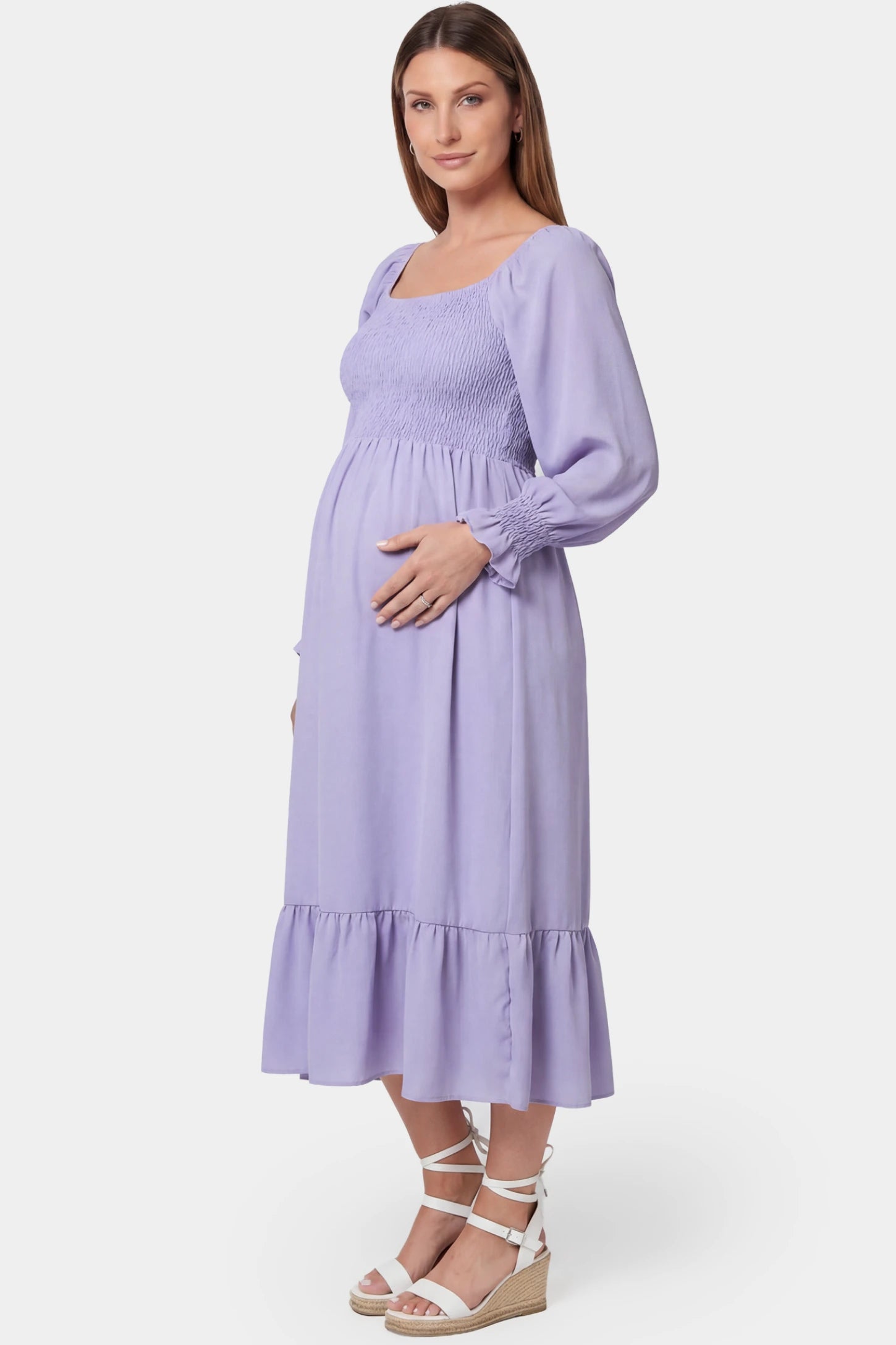Smocked Square Neck Ruffle Hem Midi Maternity Dress Smocked square neck ruffle hem midi maternity dress in purple featuring smocked bodice in side view on a pregnant model