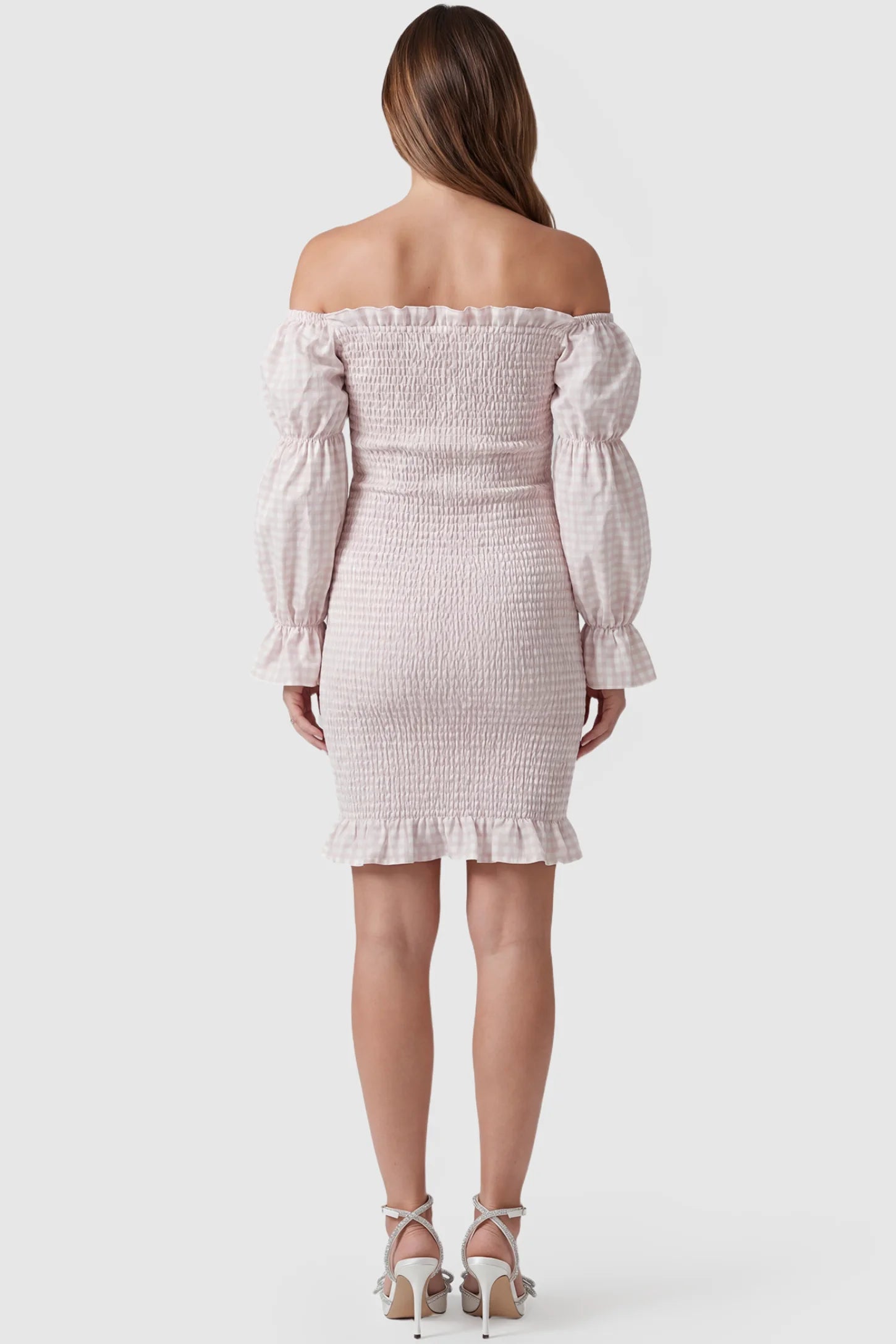 Smocked Off-Shoulder Bodycon Maternity Short Dress Smocked off-shoulder bodycon maternity short dress in white pink gingham with smocked bodice detail, back view on pregnant model