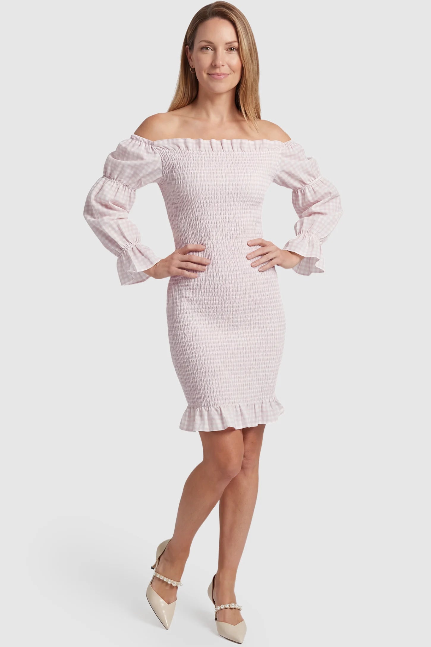 Smocked Off-Shoulder Bodycon Maternity Short Dress Smocked off-shoulder bodycon maternity short dress in white pink gingham with smocked bodice detail, front view on postpartum model