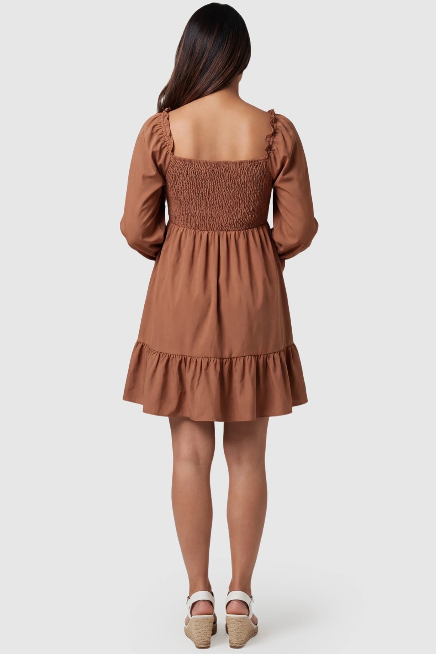 Smocked Chiffon A-Line Maternity Mini Dress Smocked Chiffon A-Line Maternity Mini Dress in Camel showing the elegant A-line drape on a pregnant model, back view.