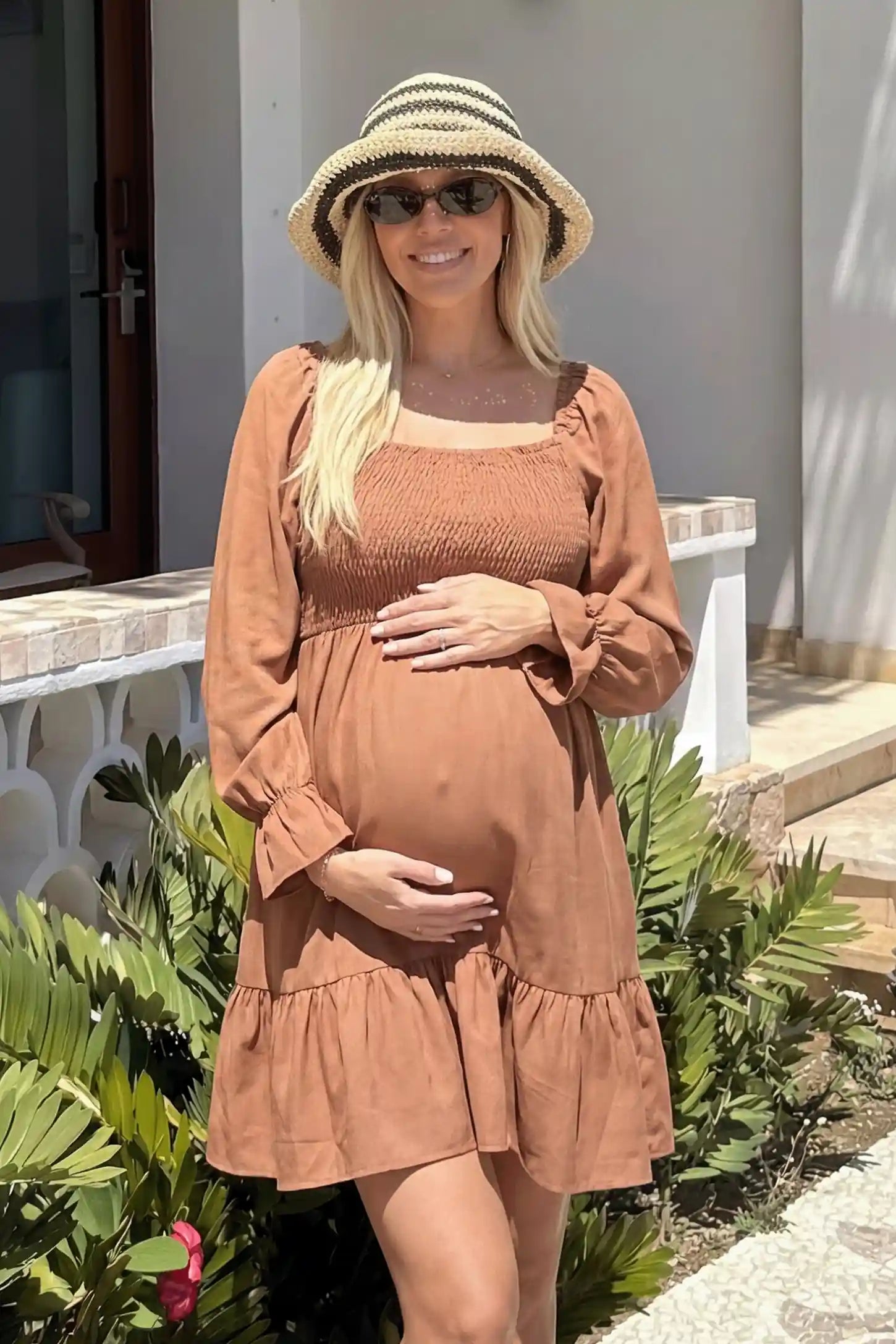 Smocked Chiffon A-Line Maternity Mini Dress Smocked Chiffon A-Line Maternity Mini Dress in Camel featuring a square neckline on a front-facing pregnant model.