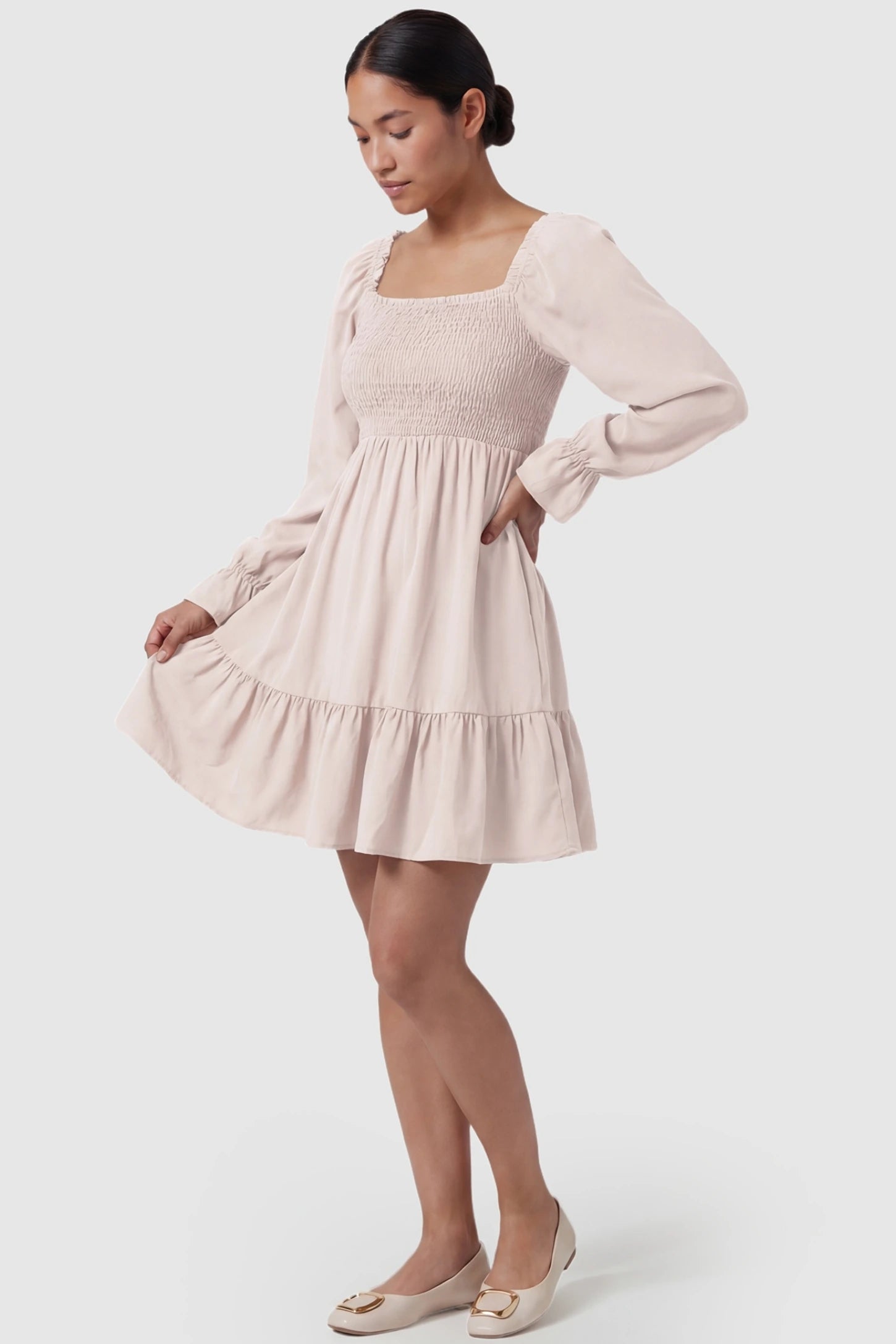 Smocked Chiffon A-Line Maternity Mini Dress Off-White Smocked Chiffon A-Line Maternity Mini Dress featuring a sleek smocked fit on a non-pregnant model, front view.