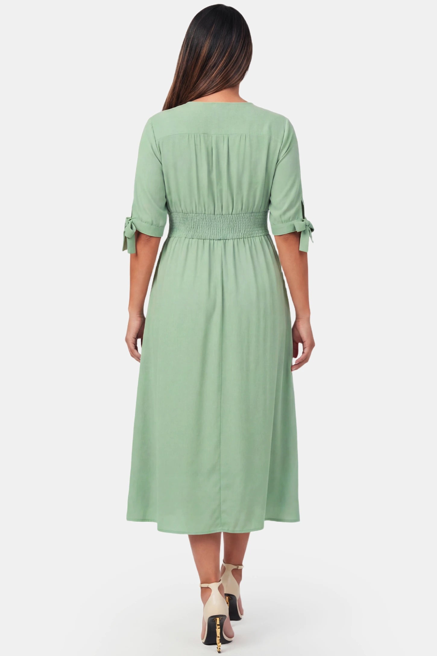 V-Neck Smocked Waist A-Line Maxi Maternity Dress V-neck smocked waist A-line maxi maternity dress in mint green featuring A-line drape in back view on a pregnant model