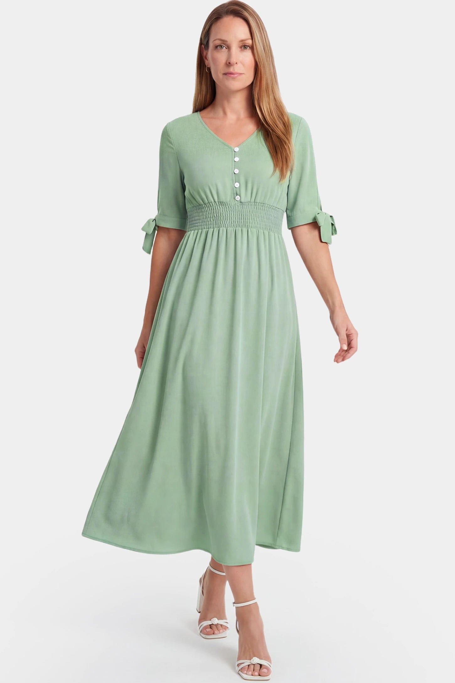 V-Neck Smocked Waist A-Line Maxi Maternity Dress V-neck smocked waist A-line maxi maternity dress in mint green featuring relaxed summer fit in full body view on a postpartum model