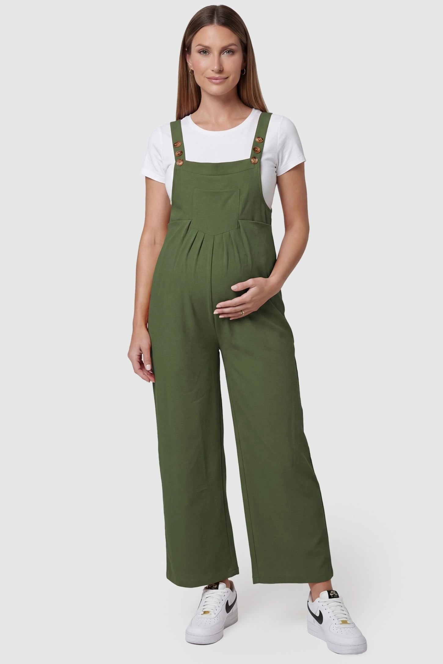 Full-Length Pocketed Maternity Jumpsuit Full-Length Pocketed Maternity Jumpsuit in Army Green featuring adjustable straps and a relaxed fit on a pregnant model, front view.