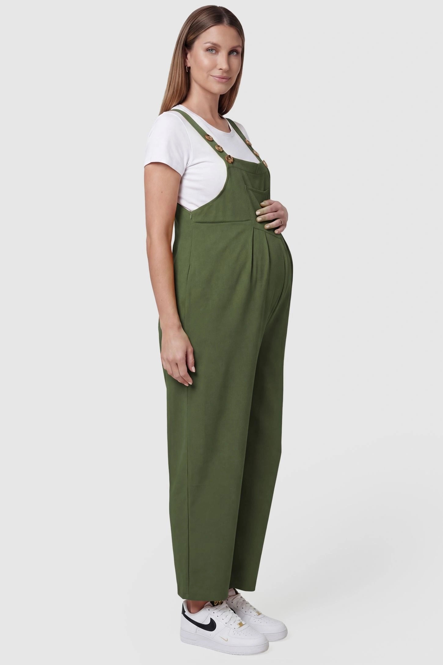 Full-Length Pocketed Maternity Jumpsuit Full-Length Pocketed Maternity Jumpsuit in Army Green featuring adjustable straps and a relaxed fit on a pregnant model, side view.
