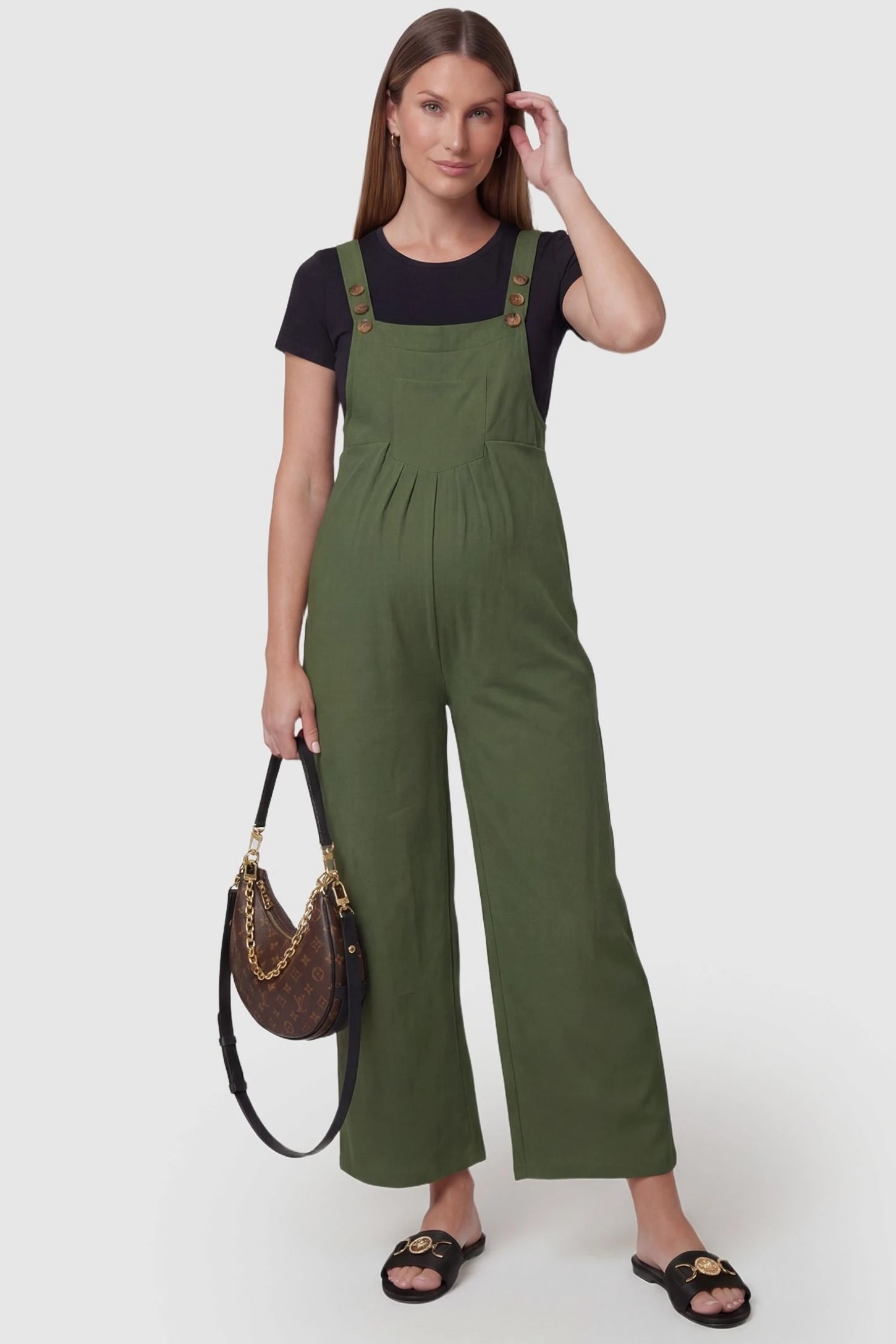 Full-Length Pocketed Maternity Jumpsuit Full-Length Pocketed Maternity Jumpsuit in Army Green featuring adjustable straps and a relaxed fit on a pregnant model, front view.
